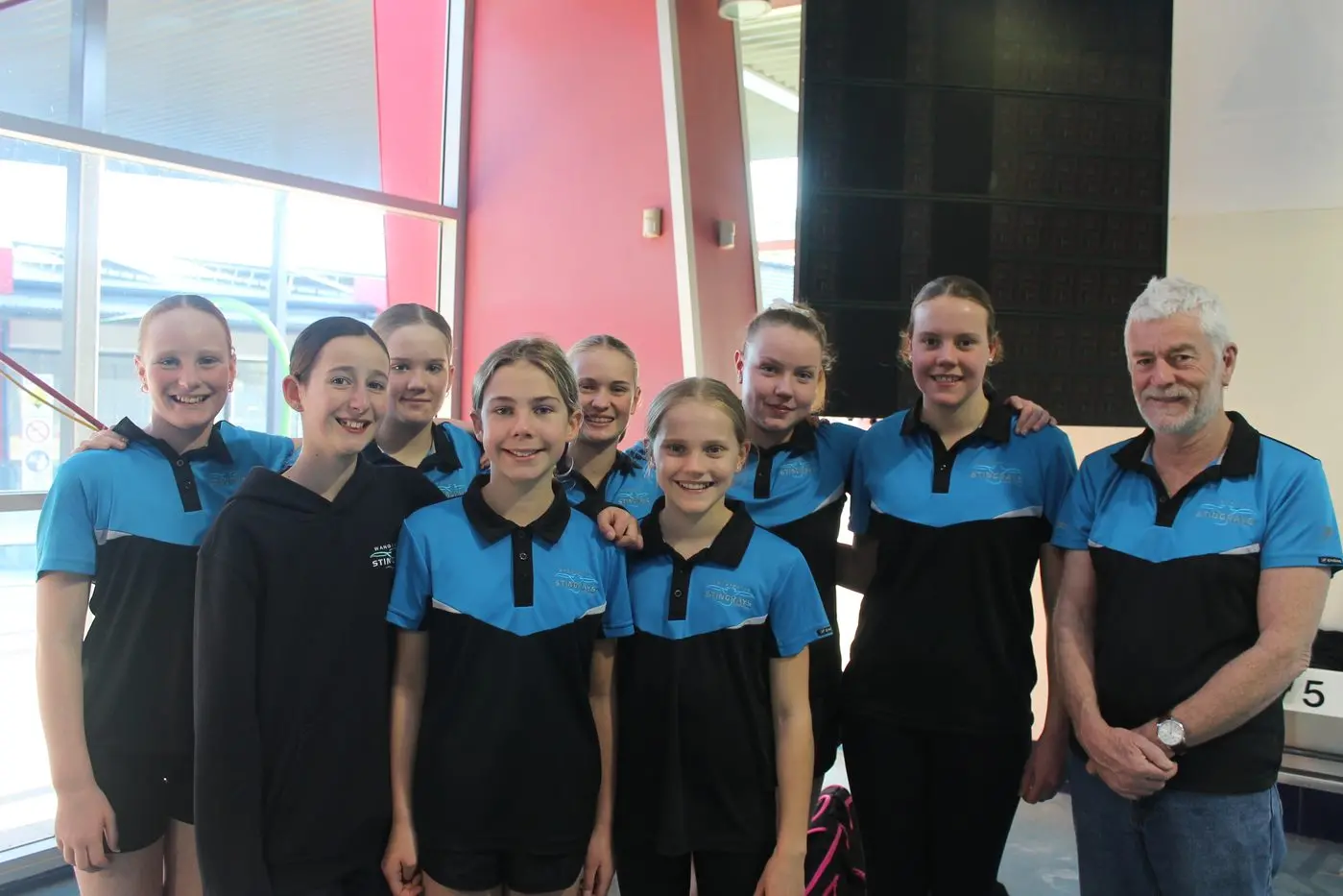 SET TO SWIM: Stingrays (from left) Isabelle Daye, Imogen Rocchiccioli, Elvie Evans-Barr, Lucy Beavis, Isla Broomfield, Eliza Looby, Hannah Sanders, Alexandra Looby, and coach Gary Bowman are ready to take on the best at Traralgon. PHOTO: Nathan de Vries