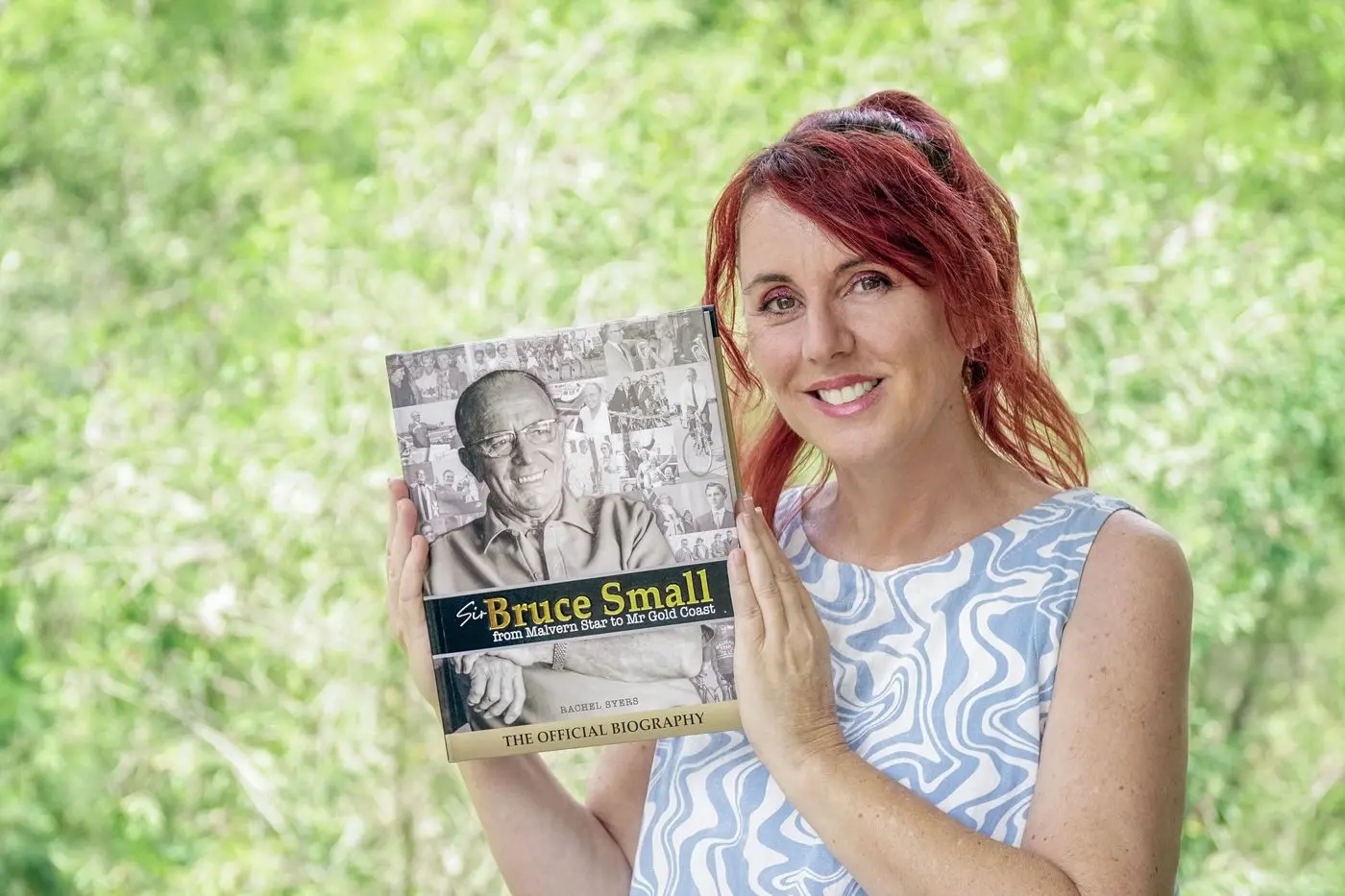 PART OF HISTORY: Author Rachel Syers with her autobiography of Sir Bruce Small, \\'From Malvern Star to Mr Gold Coast\\'.  PHOTO: Luke Sorensen