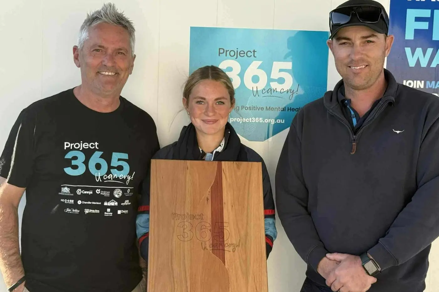 SUPPORTING THE CAUSE: Project 365 founder Pete Rourke with Mia Bernardi and Maxishine Car Wash\\' manager Chris Camm, and the chopping board Mia created featuring the Project 365 logo, which was auctioned at Saturday night\\'s gala ball.