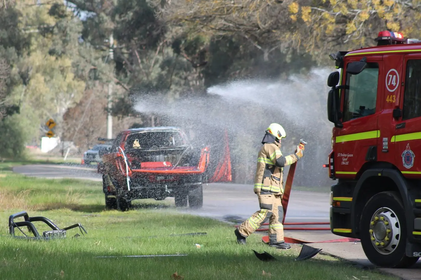 THE BIG BANG: Firefighters work to cool down an acetylene cylinder following a gas explosion at the rear of a utility, which let off a loud bang and set the vehicle alight on Frank Hayes Drive Tuesday morning. PHOTOS: Bailey Zimmermann