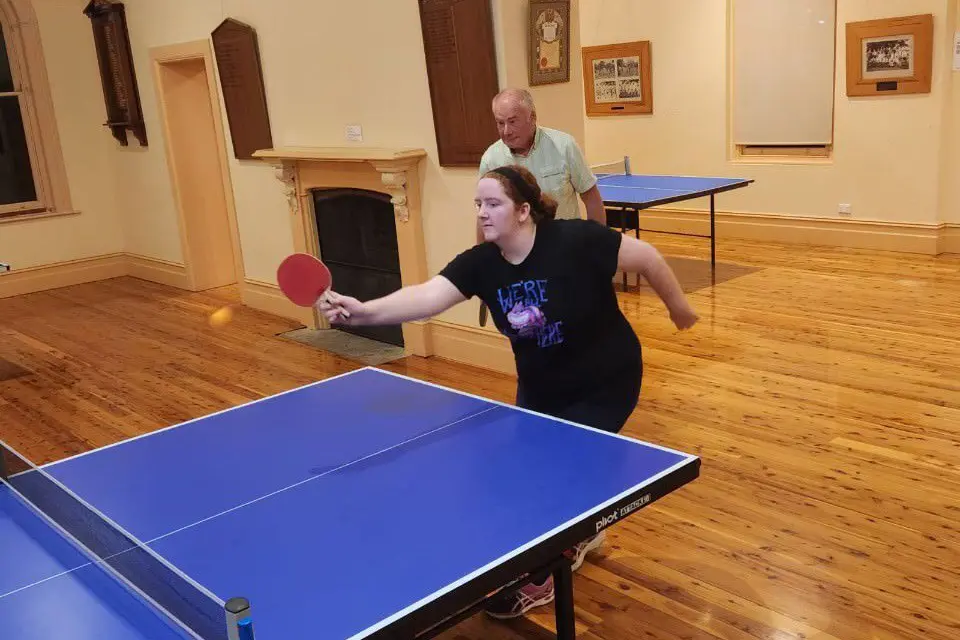 IN ACTION: Phoebe Bosley at full stretch for a short ball in her match with partner Graham Stephens.