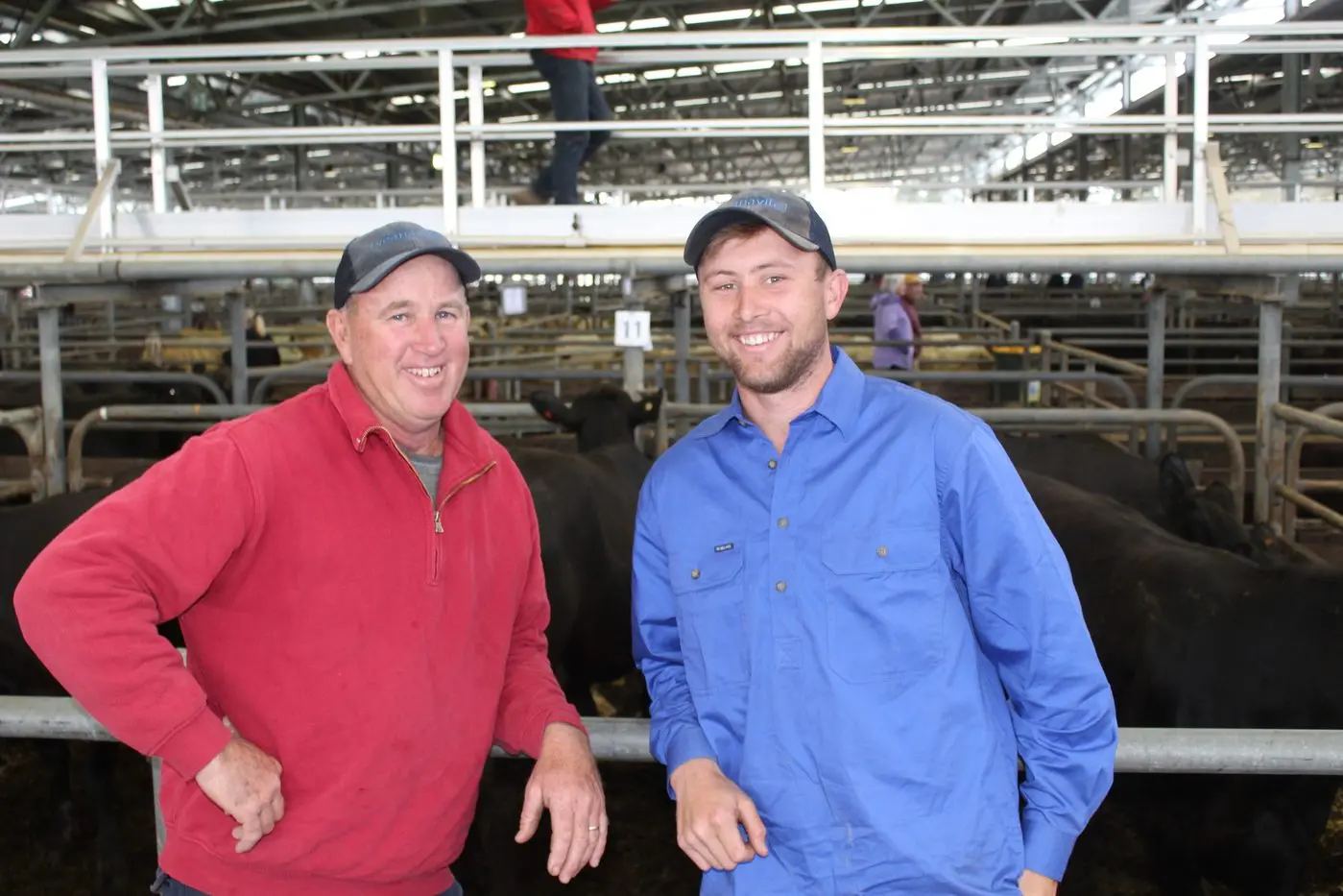 MONEY IN THE MUD: Everton cattle farmers Paul and Lachie Hourigan brought along 22 head of Angus heifers and were pleased when their expected prices were exceeded at the monthly store cattle sale at Wangaratta last Friday. PHOTO: Bailey Zimmermann Id:31880