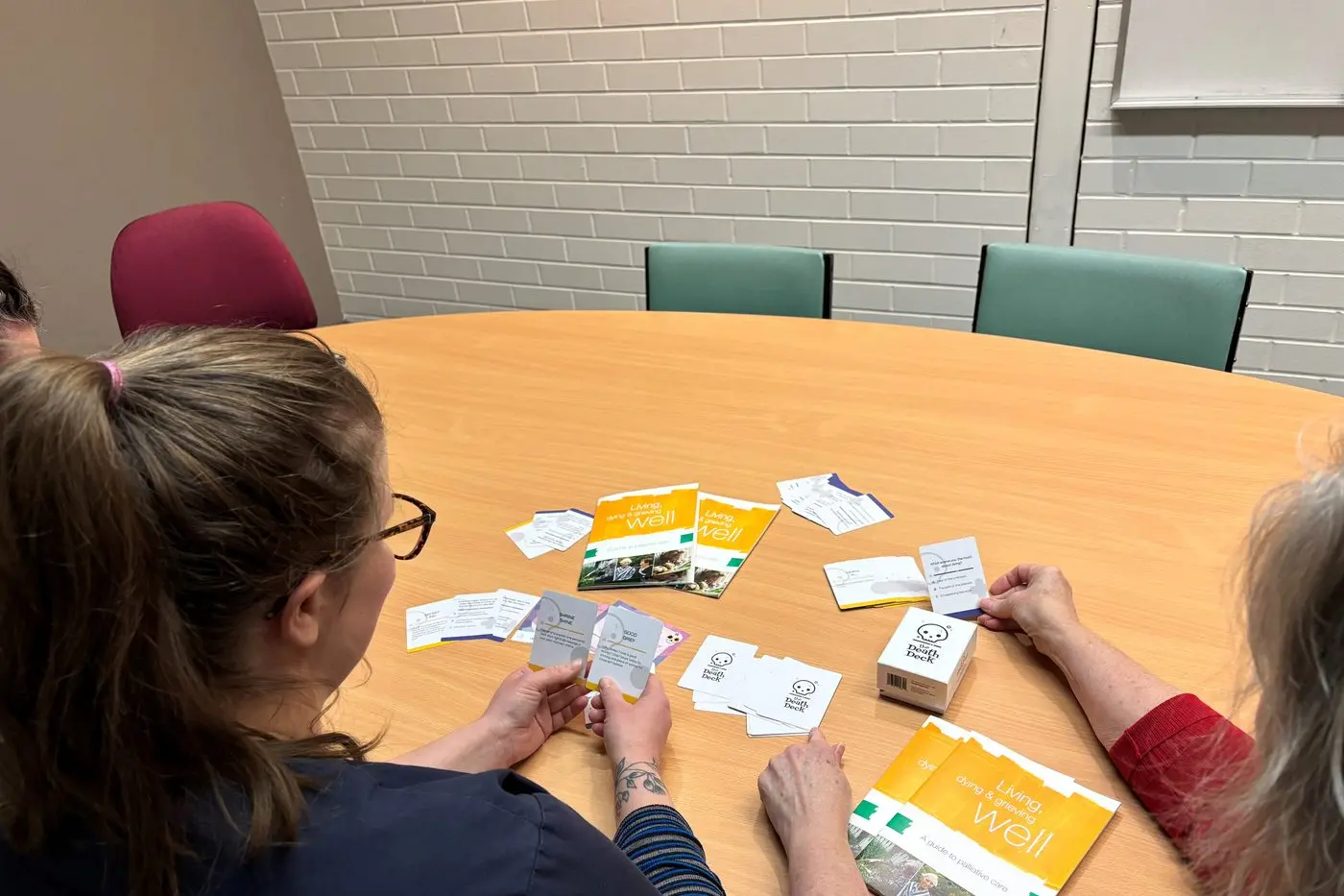 CONVERSATIONS AROUND DEATH: Participants at a Death Caf\\u00E9 exploring death, grief and loss using EOL cards to help facilitate conversations about end-of-life wishes.