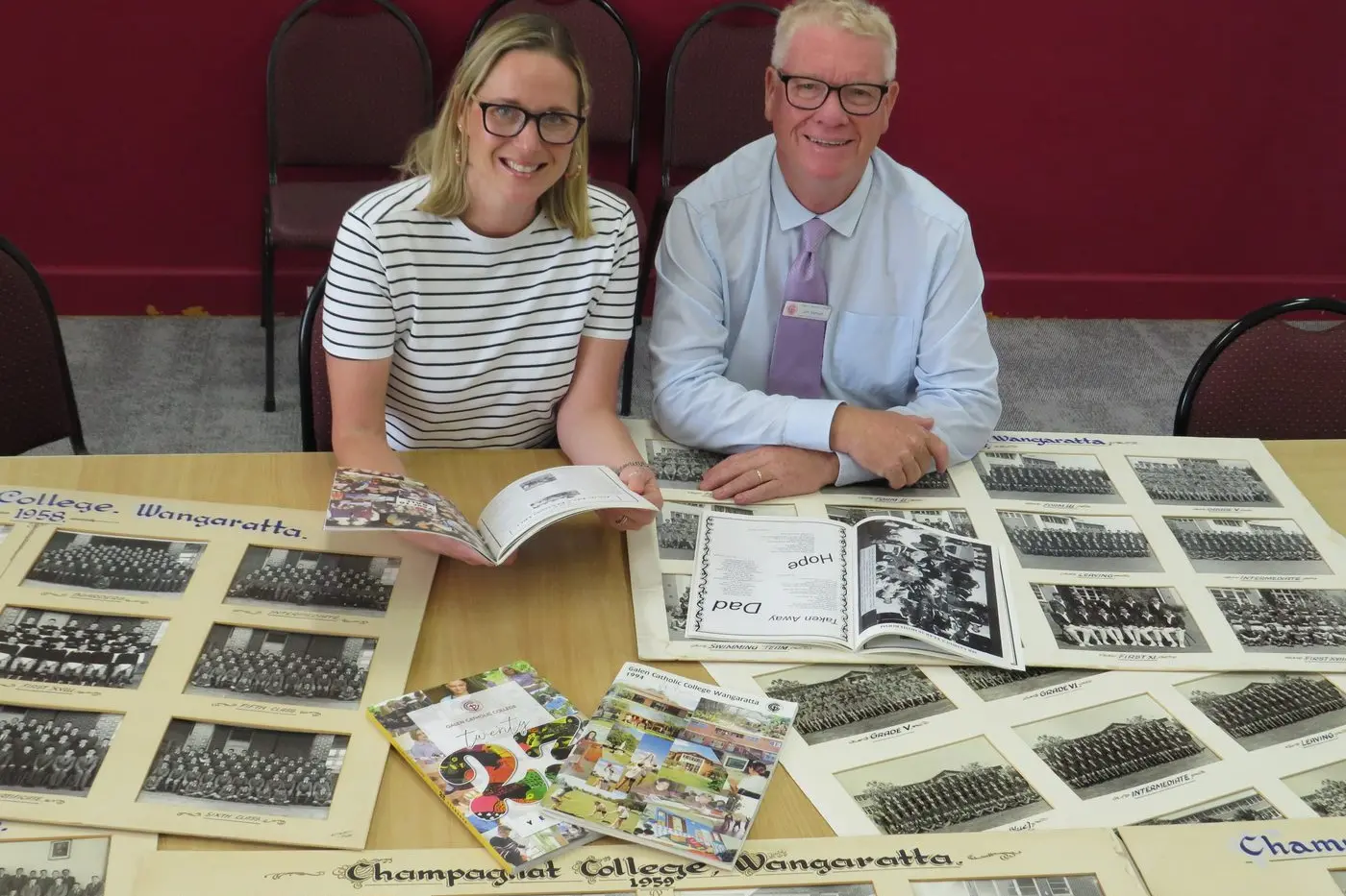 WEALTH OF MEMORIES: Galen Catholic College marketing manager/registrar Zoe Cooper, and interim principal Jim Samon look through some of the school\\'s memorabilia in the lead-up to this year\\'s 50th anniversary celebrations.  PHOTO: Simone Kerwin