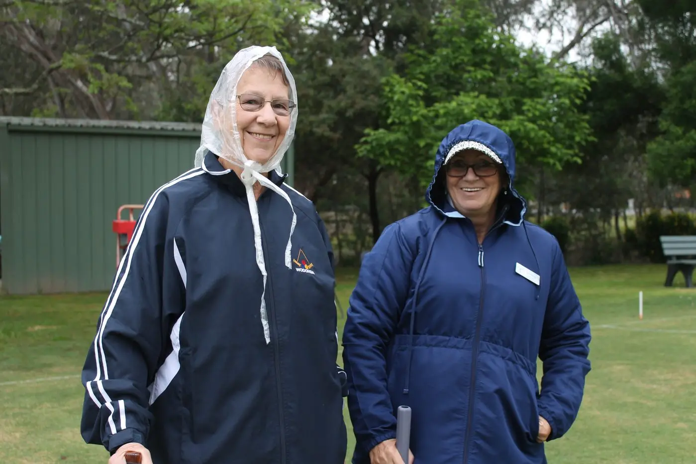 WRAPPED UP: Leah Venville and Lorraine Williams braved the wet weather.