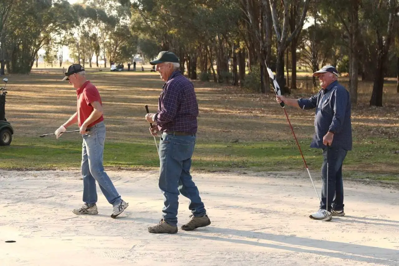 MAN BEHIND REVITALISATION: Barry Byrne (centre) and his years of dedicated volunteerism has been recognised with a life membership at the Boorhaman Golf Club.