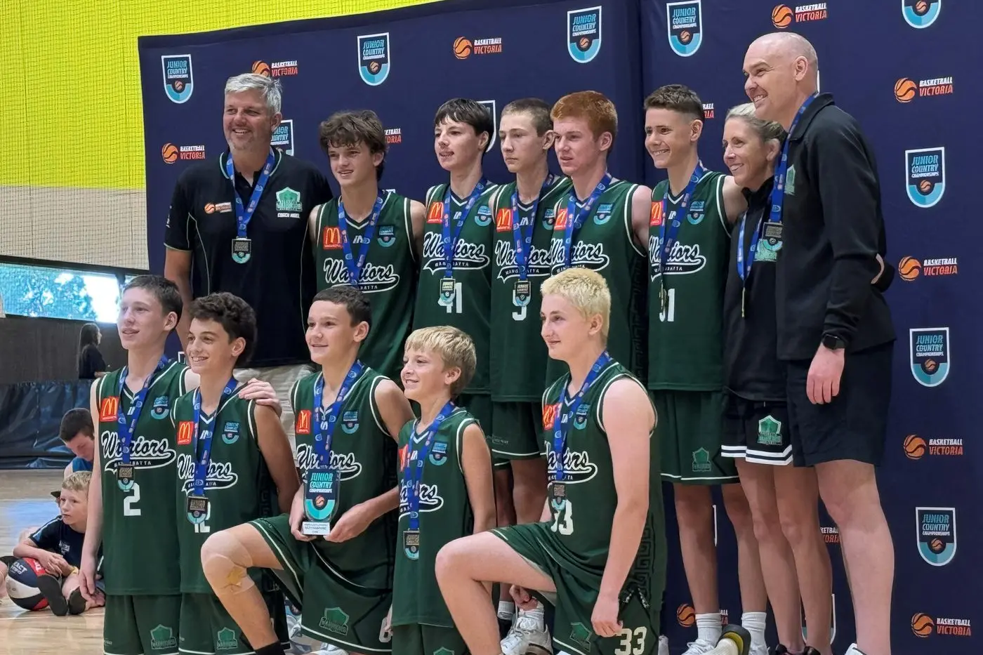 CHAMPIONS: Wangaratta\\'s division four state champion side (back from left) Nigel Kain (assistant coach), Harris Kain, Oskar McGahan, Brock Buckland, Henry Ackerly, Cooper Cassidy, Amanda Cassidy (team manager), Ian Pople (head coach), (front from left) Connah Hart, Lukas Cannata, Jack Pople, Ollie Parr, and Ethan Damon.\\n