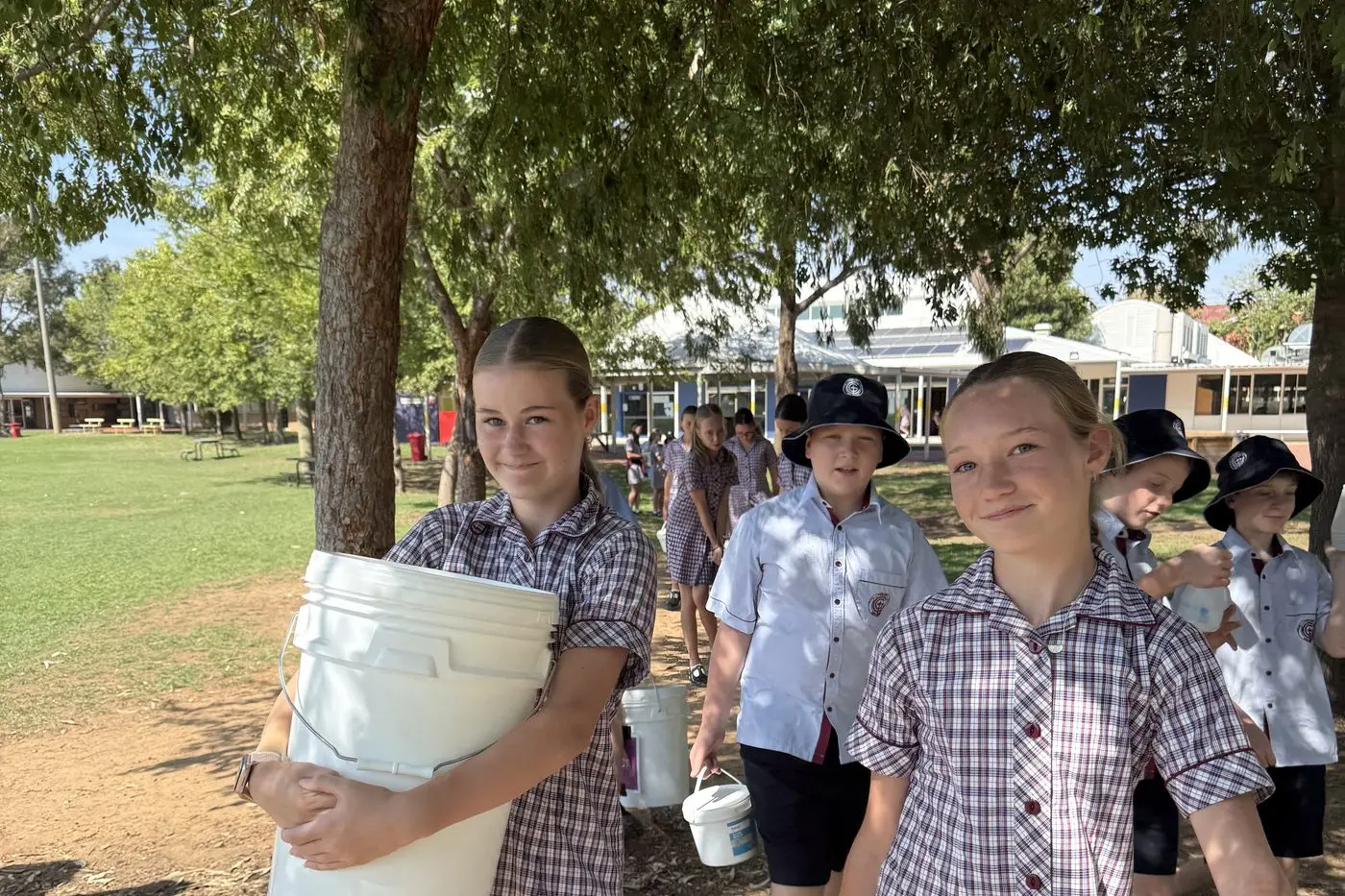 Year 7 Galen students (facing the camera L-R) Evie Steer, Isaac Gardner and Charlotte McMahon feeling the weight on their \\u201CBig Water Walk\\u201D fundraising activity.
