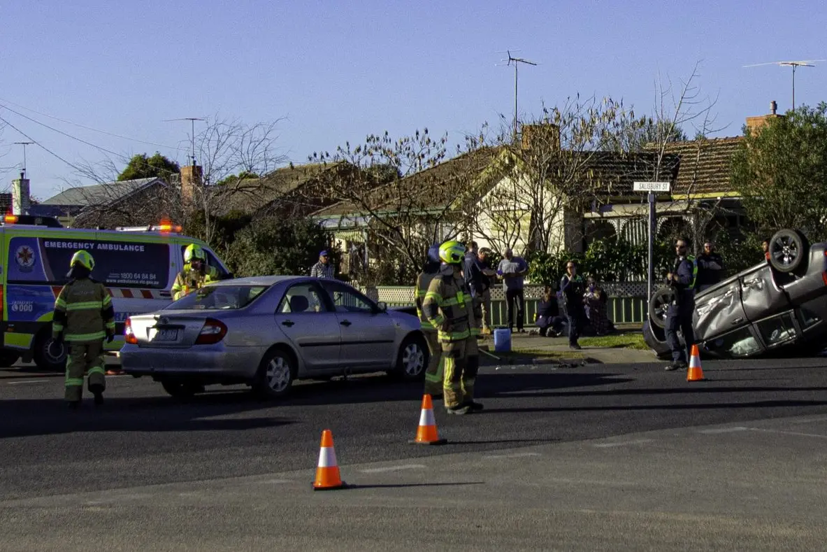 CRASH SCENE: Emergency service workers at the two car collision at the Cribbes Road and Salisbury Street intersection on Sunday. PHOTO: Mandi Chrystal