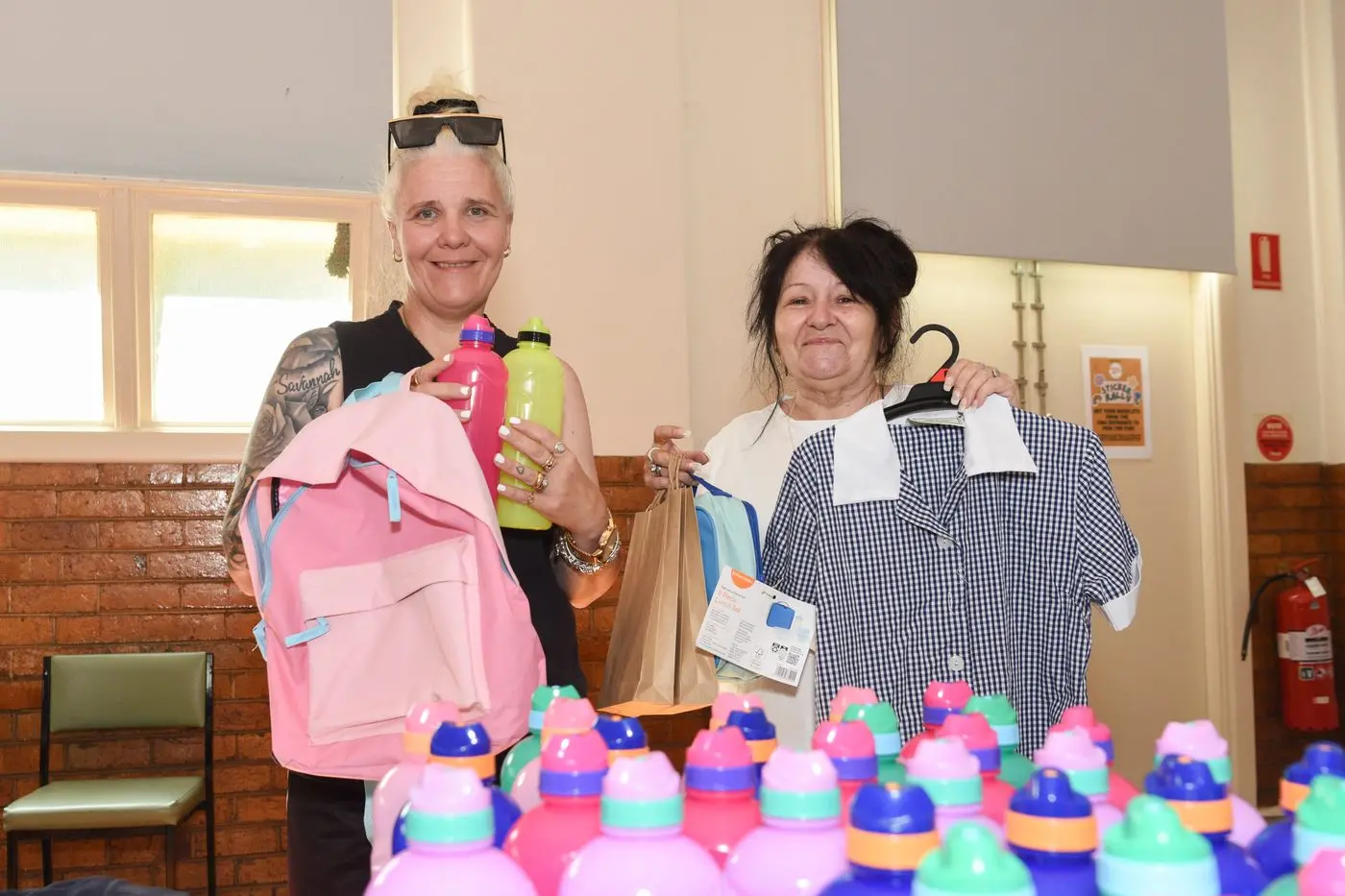 SHARE THE LOVE: Nicole Robinson receives school items from Donna Vickers. PHOTOS: Kurt Hickling.