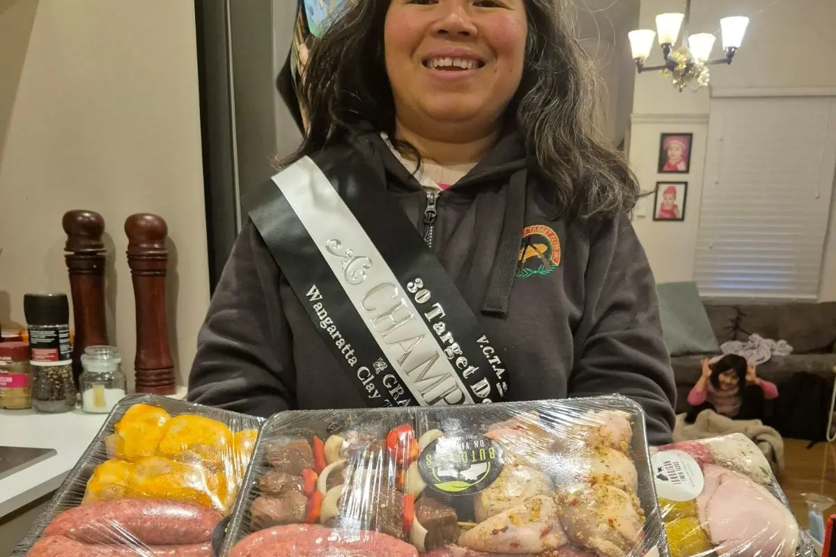 ALL SMILES: Kanya Thumsud with her winner\\'s meat tray after Saturday\\'s shoot.