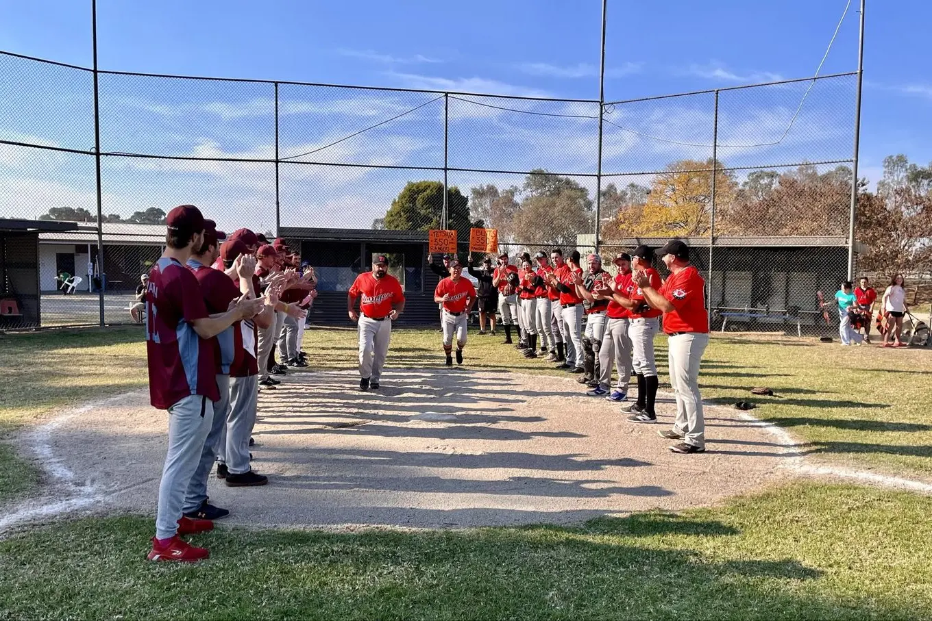 RANGERS REGULARS: Baseballers form a guard of honour to congratulate Rob Seymour and Tetsu Kamiyama on their 350th games.