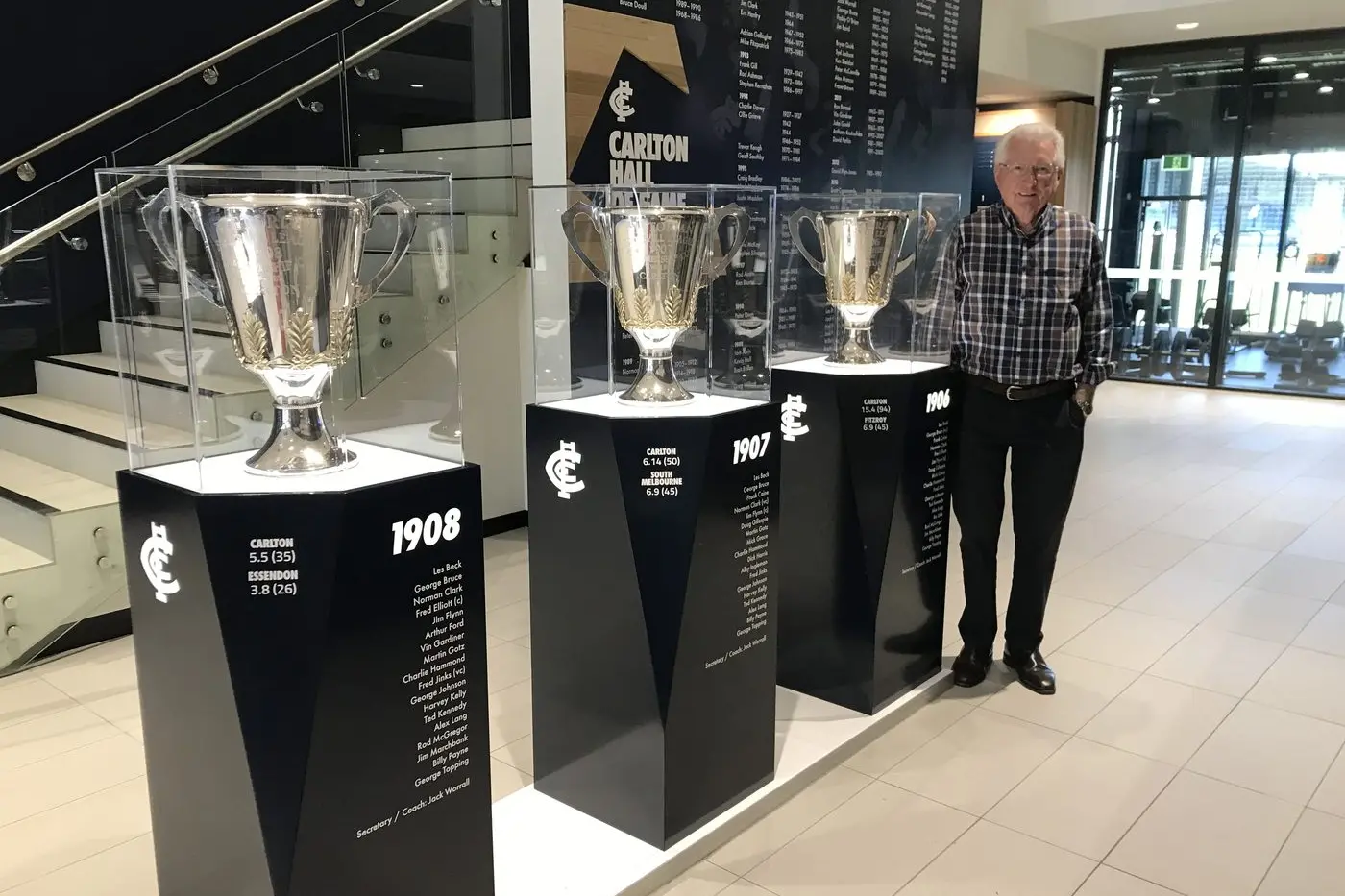 RICH LEGACY: Pat Flynn, Carlton Hall of Famer Jim Flynn\\'s grandson, with the cups from the three premiership sides Jim was a part of - 1906, \\'07 and \\'08; he was captain from 1905 to \\'07.