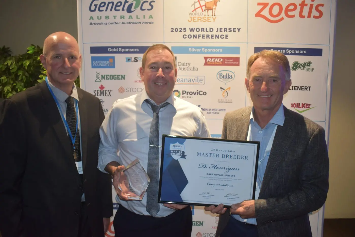LOCAL RECOGNITION: Jersey Australia (JA) Master Breeder Rohan Sprunt (left) and JA president Geoff Akers present Milawa farmer Darryn Hourigan with his Master Breeder award.