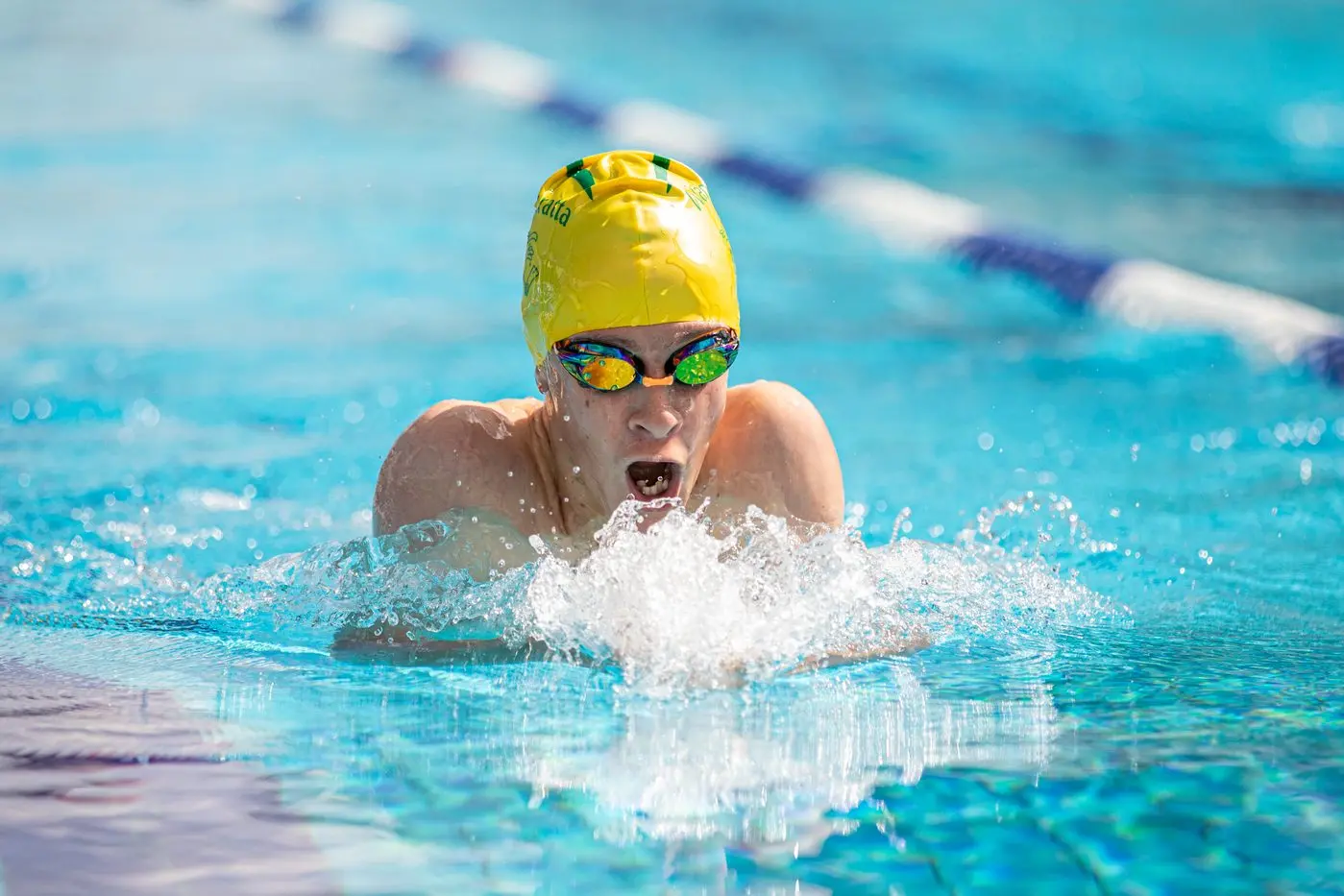 KEEP ON SWIMMING: Harry Chandler takes a breath in his breaststroke race. PHOTOS: Marc Bongers