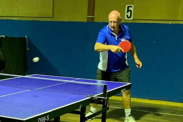 RETURNED: Tim Oliver paddles the ball back over the net.