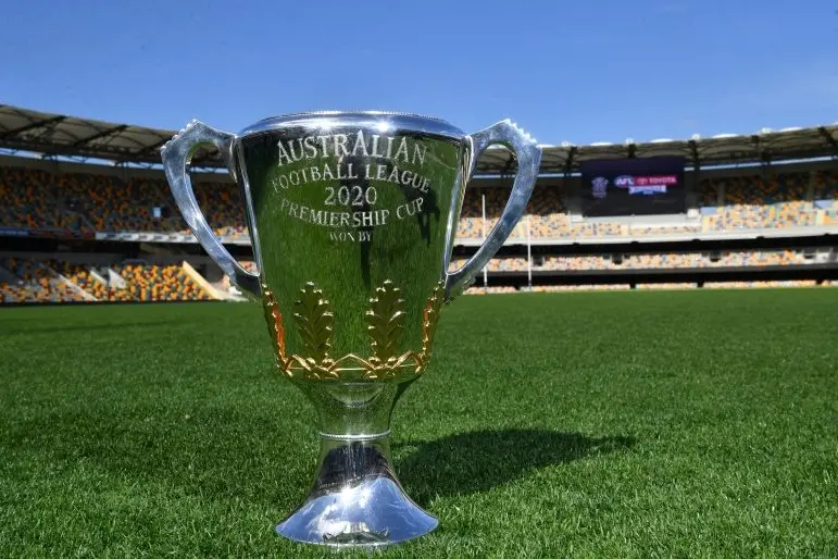 The AFL Premiership Cup is seen on the Gabba surface after the announcement that Brisbane will host the AFL Grand Final during a press conference at the Gabba in Brisbane, Wednesday, September 2, 2020. The AFL have announced that the Gabba will host the Grand Final on October 24 in Brisbane. The first time in the history of the AFL/VFL that the Grand Final has been held outside of Victoria. (AAP Image/Darren England) NO ARCHIVING