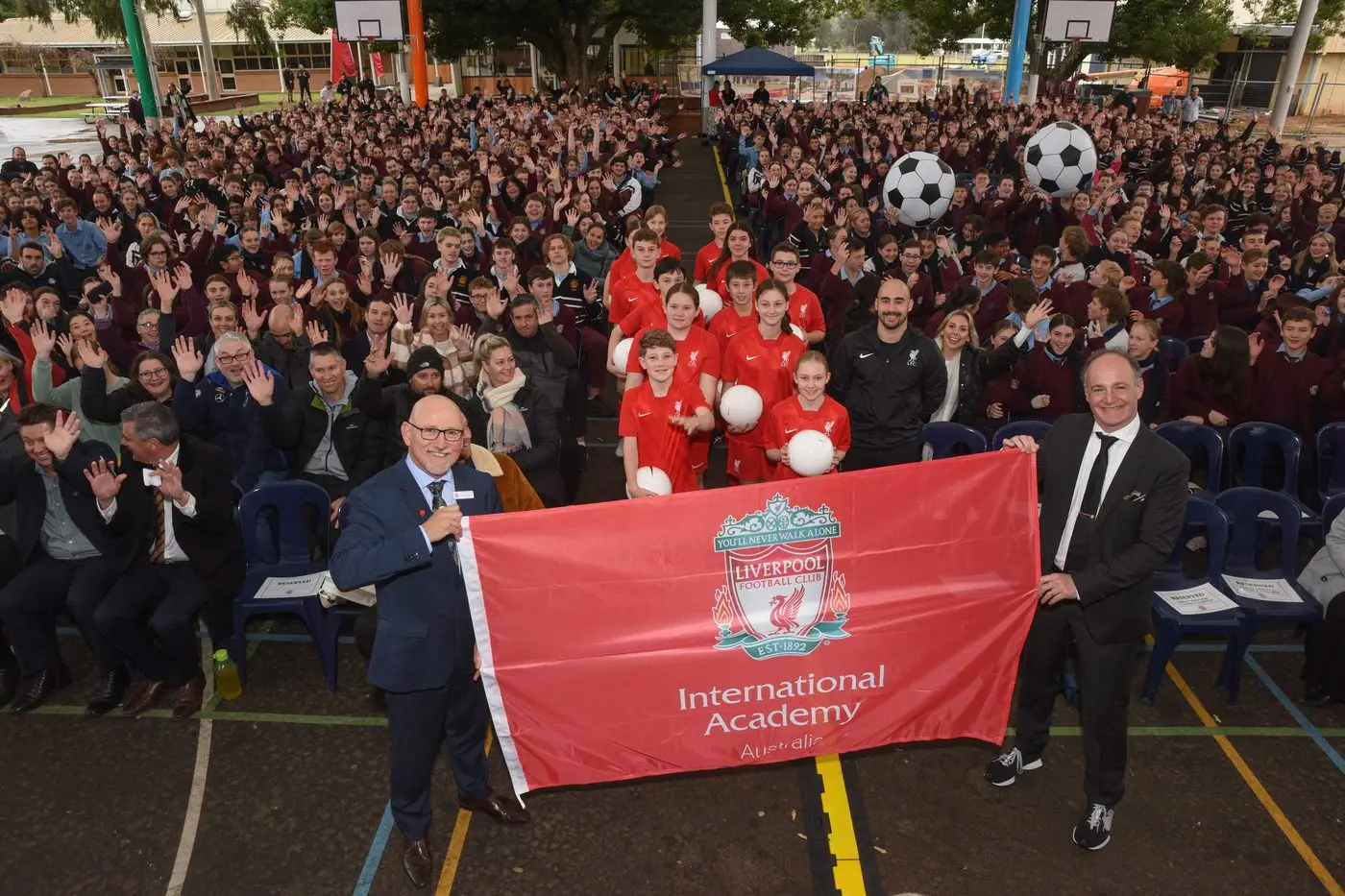 EXCITED: Galen College principal Darta Hovey, and Kevin Kalinko, director of LFC International Academy Australia, make the arrangement official in front of a whole\\u2013school assembly.  PHOTO: Kurt Hickling Id:42068
