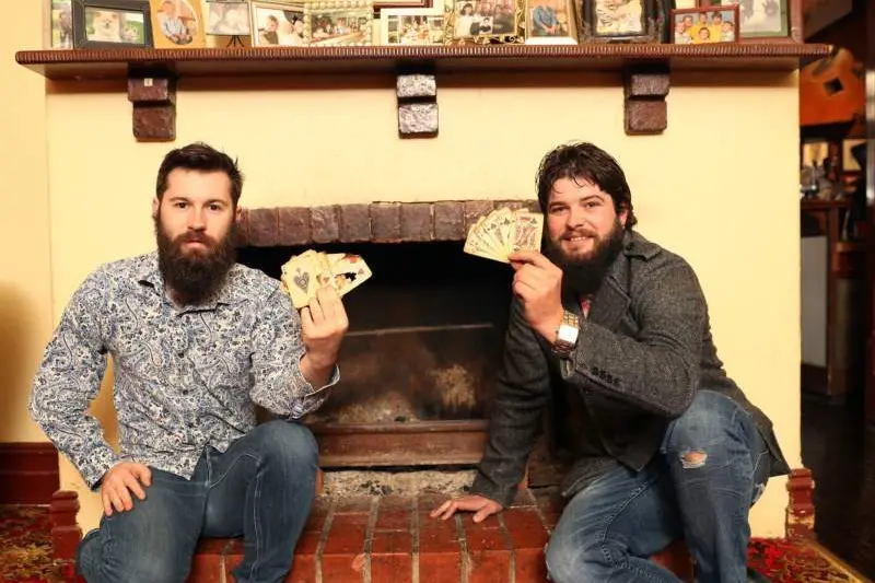 WHAT A FIND: Jimmy Ladgrove and Sam Richardson with the playing cards, discovered under the mantlepiece of this fireplace.  PHOTO: Kieren Tilly\\n
