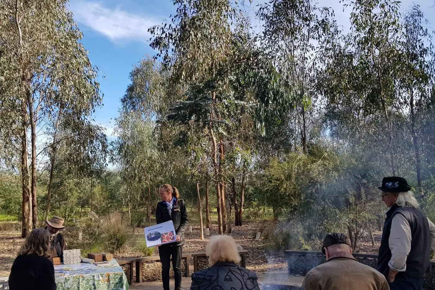 BUSY BEES: Karen Retra looks on as one of the workshop participants examines the native bee hotels. PHOTO: North East Catchment Management Authority.  Id:26002