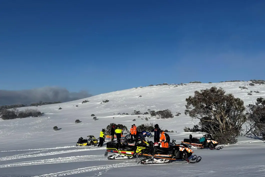 SAFE AND SOUND: Ambulance Victoria, VicPol and VICSES members rescuing Michelle McRae and Jon Miller in better weather in the Bogong High Plains.