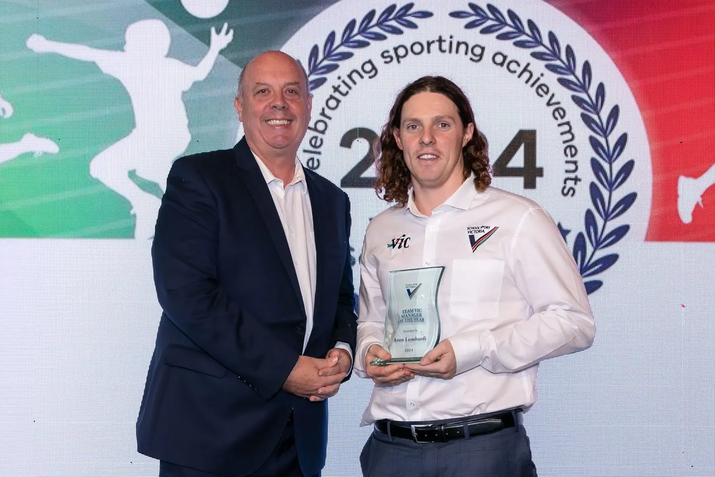 HONOURED: Aron Lombardi, a teacher at Galen Catholic College, received the 2024 Team Vic Manager of the Year Award for his work with the Victorian under 15 boys AFL team.  He is pictured with Jamie Parsons, chief executive officer of School Sport Victoria. 