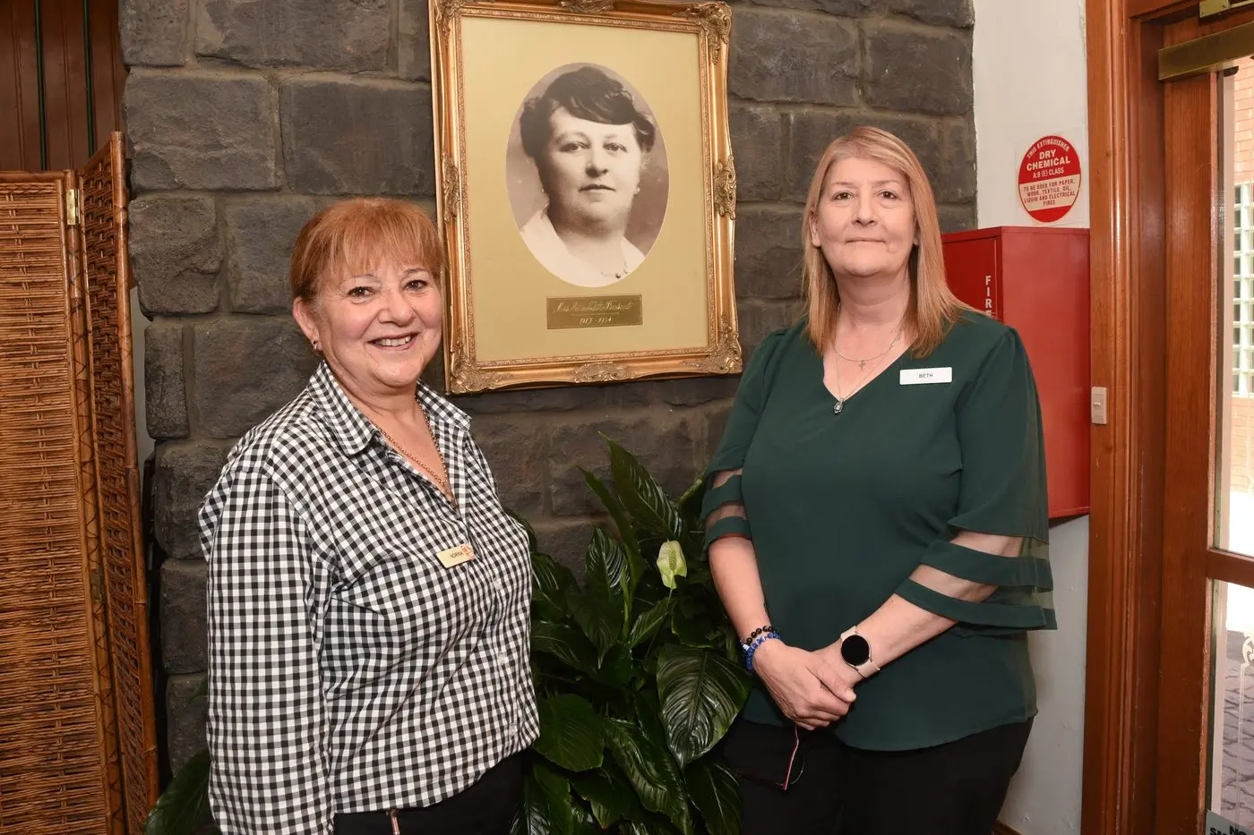 HONOURING HISTORY: The Pinsent manager Beth Watson and duty manager Norma Smith with the portrait of the hotel\\'s namesake Annie Edith Pinsent. PHOTO: Kurt Hickling  Id:36149
