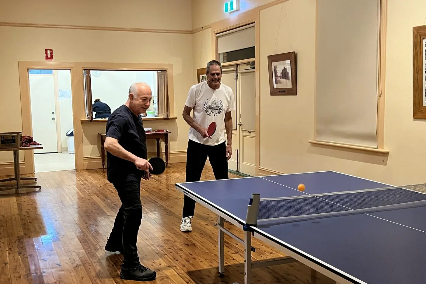 LONG AND SHORT OF IT: The towering Gary Coad (right) and slight Manni Poulos team up at Monday night\\'s Oxley table tennis meeting. PHOTOS: Neil Brock