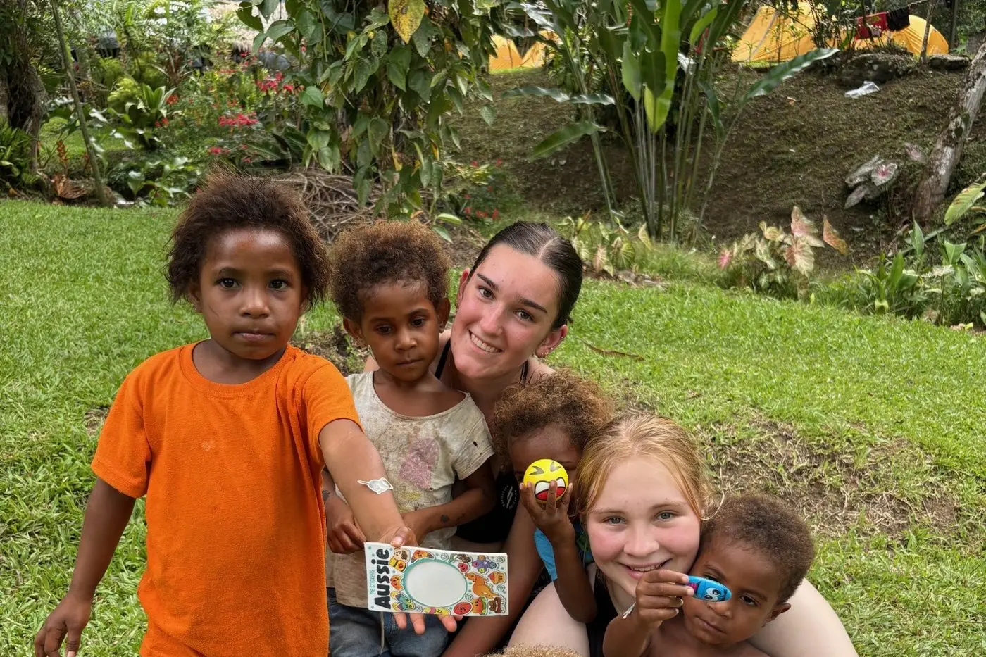 LOCAL COMMUNITY: Charli Wright and Makiah McCallum with local village children.