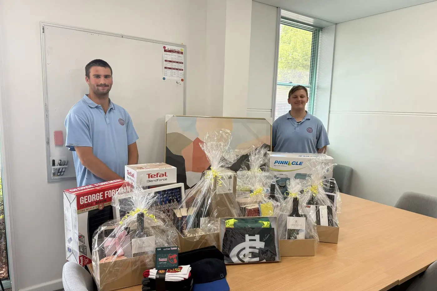 UP FOR THE TAKING: Galen Catholic College students Owen Dinsdale (left) and Aidyn Dromi showcasing the prizes up for grabs in the year 11 Vocational Major Personal Development Skills subject community raffle, with funds raised to be given to Northeast Health Wangaratta.