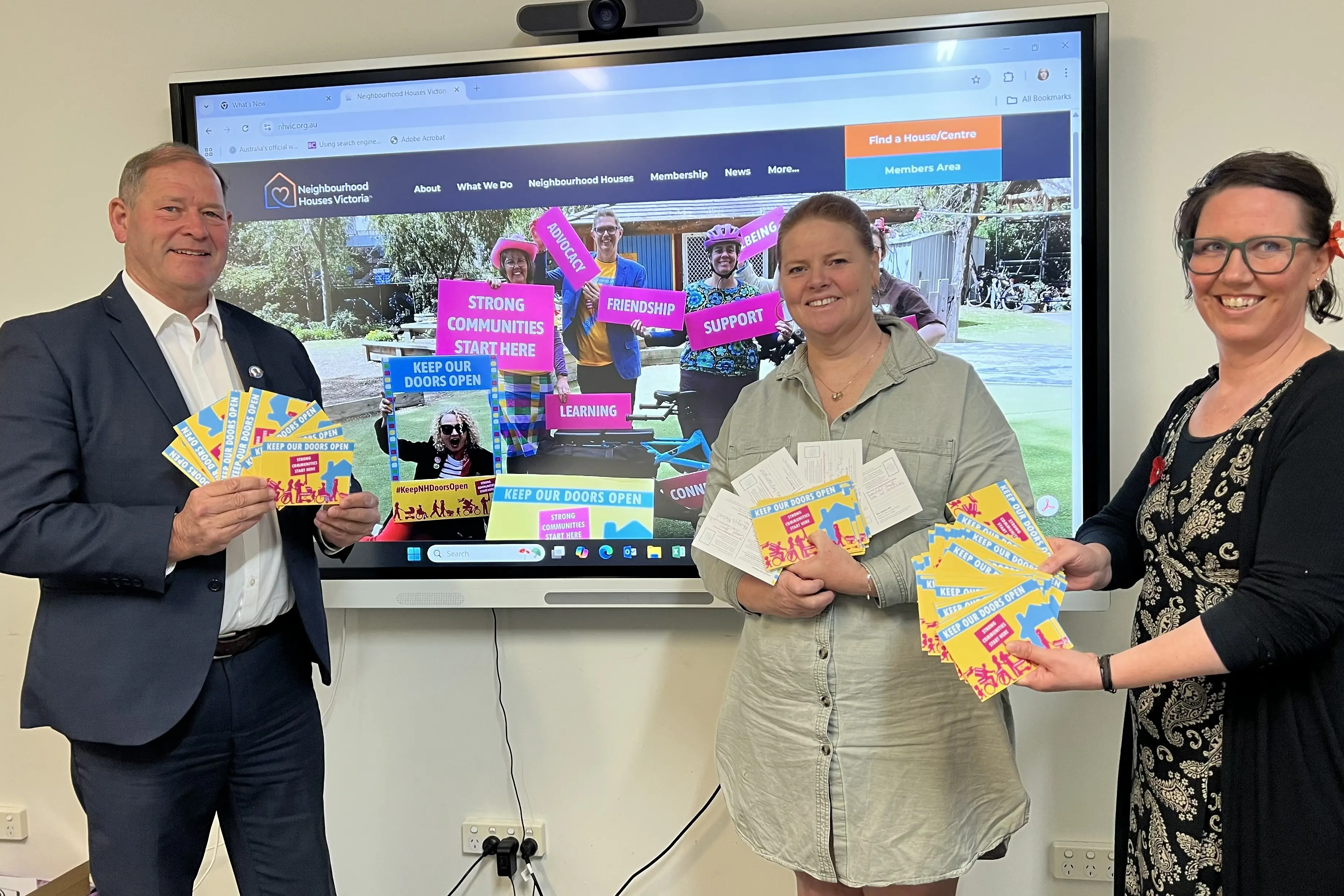 <p>PASSING ON THE MESSAGE: Tim McCurdy (MLA, Ovens Valley) accepts a collection of postcards from Pangerang Community Hub executive officer Tennille Hall, and Open Door Neighbourhood House executive officer Loretta Waters.</p>\\n