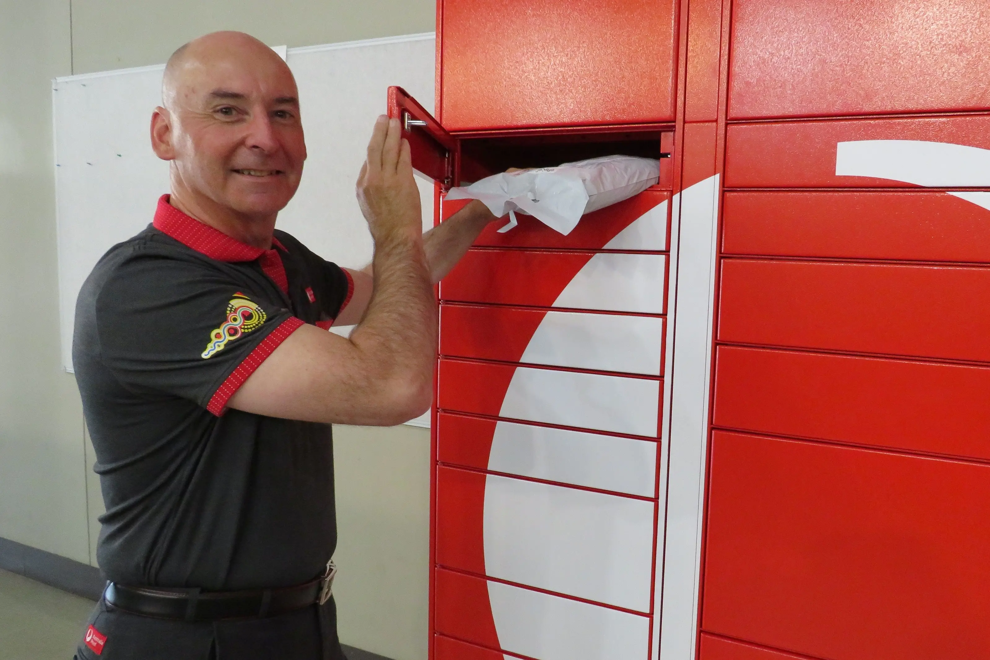 <p>CONVENIENT DELIVERY: Australia Post Wangaratta\\'s Garry Bennett places a parcel in a locker ready for collection.  PHOTO: Simone Kerwin</p>\\n