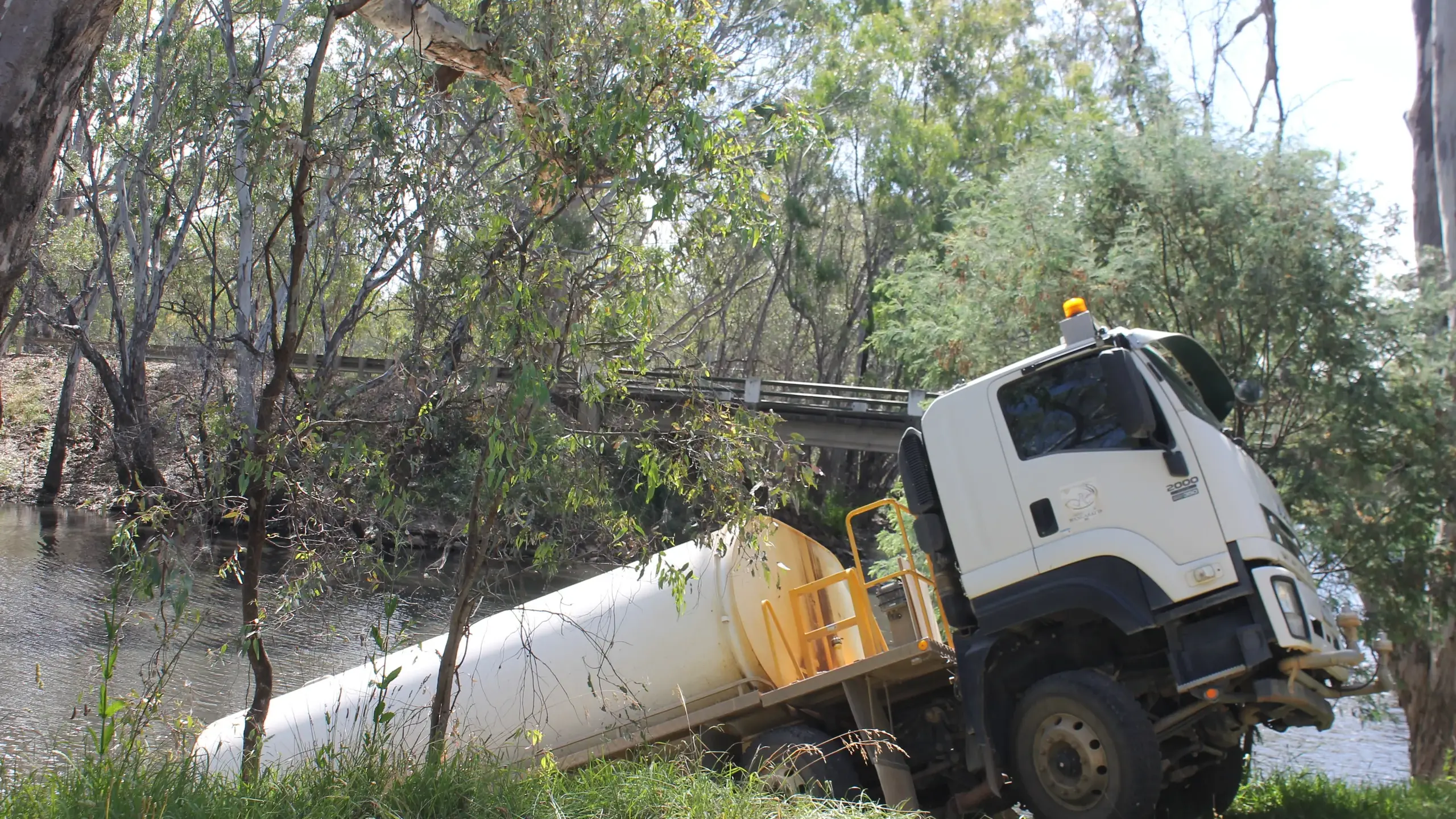 Council worker breaks foot after water tanker plunges into creek