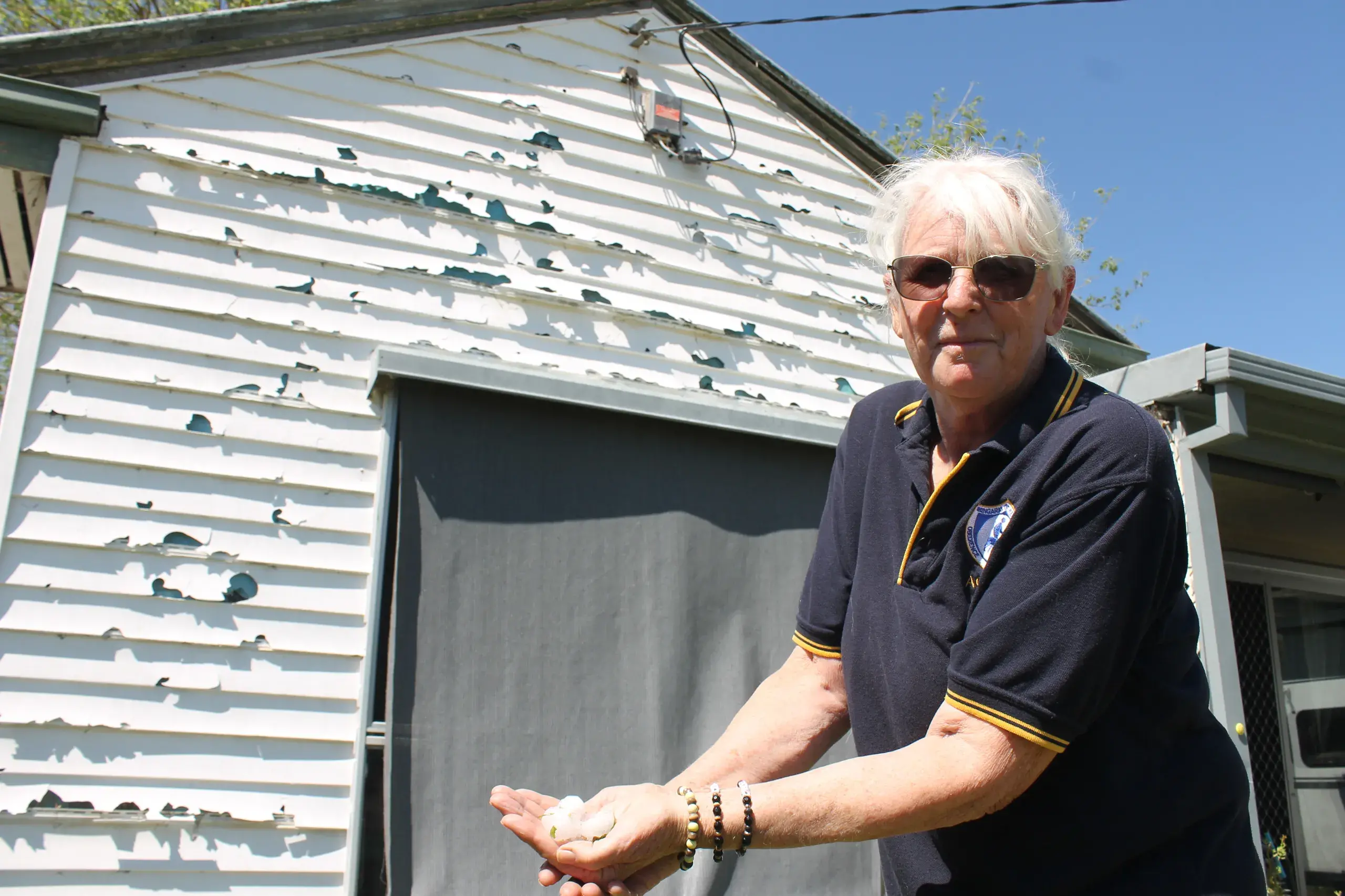 <p>HAIL MARY: Di Costello was left to picking up the large hailstones which thundered down on her home on Thursday night leaving widespread damage in an isolated storm which hit parts of Wangaratta. PHOTO: Bailey Zimmermann</p>\\n