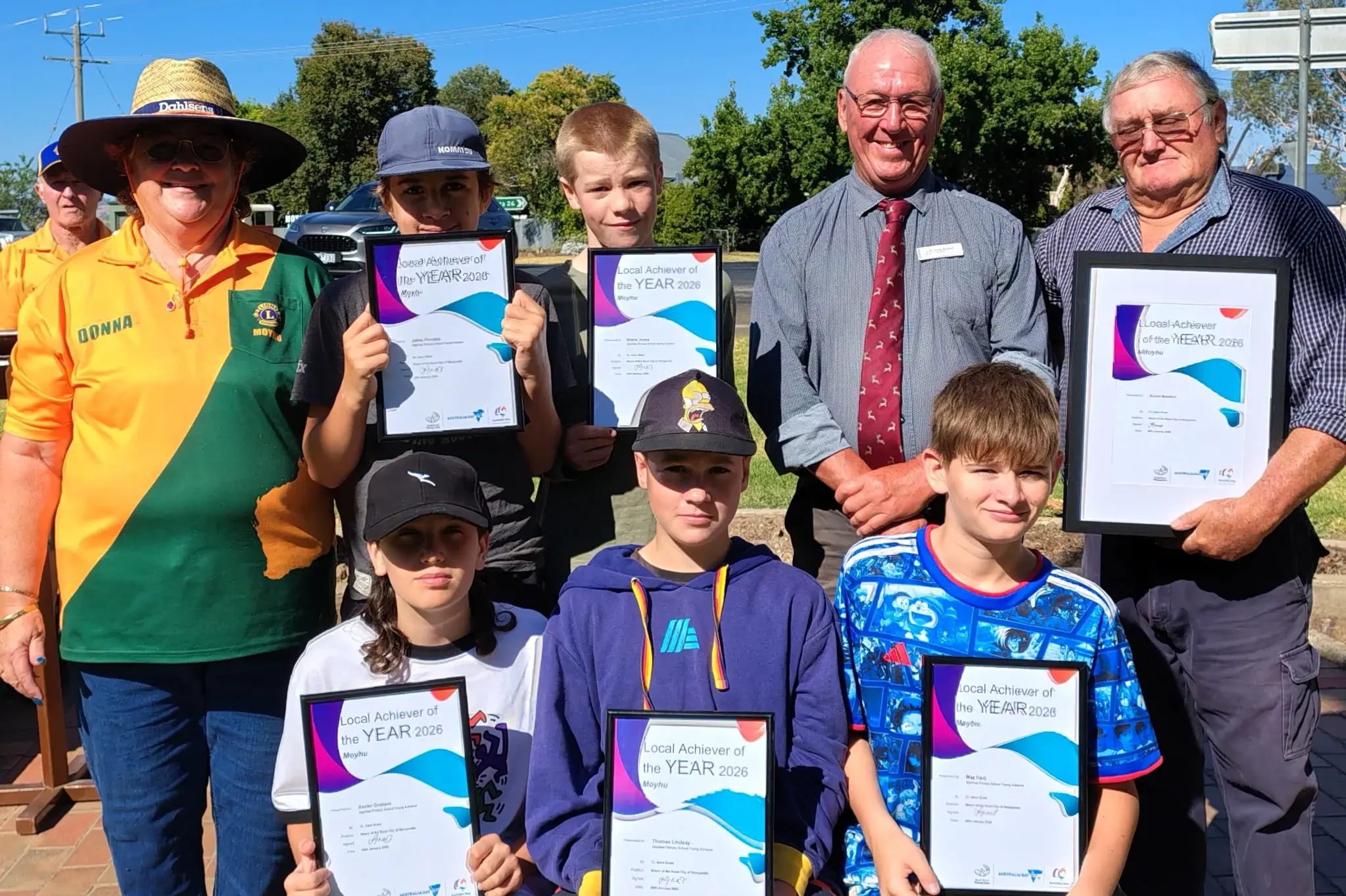 <p>PROUD ACHIEVERS: Gathered at the Moyhu Australia Day breakfast were (back from left) Moyhu Lions Club president Donna Handcock with Jakey Prentice, Bryce Jones, Cr Harry Bussell, Local Achiever Kevin Newton, and (front, from left) Xavier Graham, Tom Lindsay and Max Hadj. PHOTOS: Nicole Lindsay</p>\\n