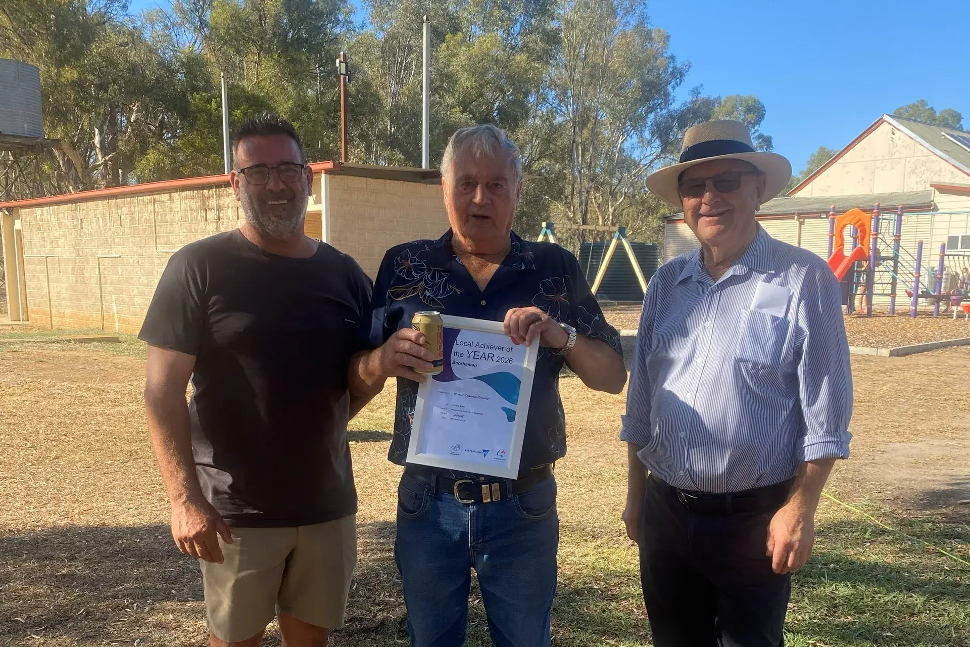<p>WORTHY RECIPIENT: Boorhaman Recreation Reserve President Nathan Bell (left) presented the Local Achiever award to \\'Chuddy\\' Chandler, with Cr Harvey Benton extending his congratulations. </p>\\n