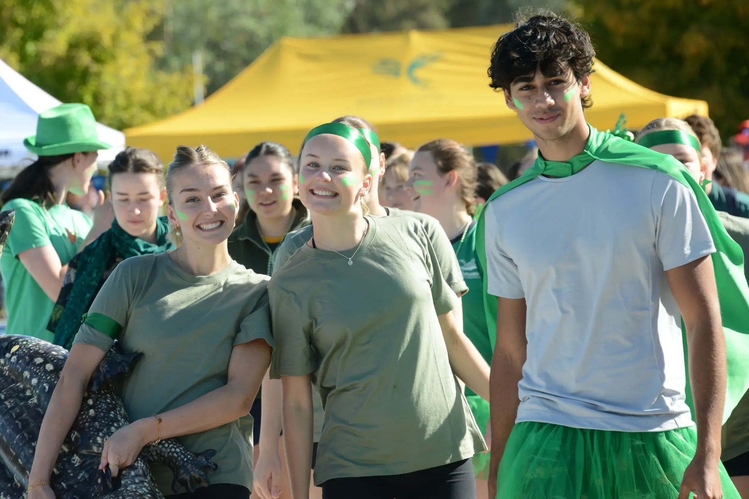 <p>GREEN ARMY: Year 12 students Stevie Driscoll, Ellie Meggs and Luka Hildebrand soak up the atmosphere.</p>\\n