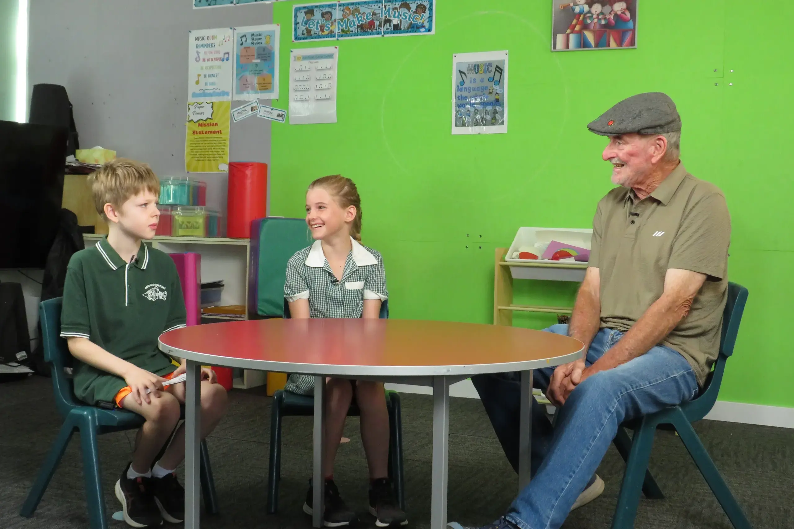<p>FOR THE ARCHIVES: Former Carraragarmungee Primary School principal Peter Daws chats with current grade four students Mason Webbers and Milly Richardson as part of the 150th anniversary film being developed. PHOTO: Simone Kerwin</p>\\n