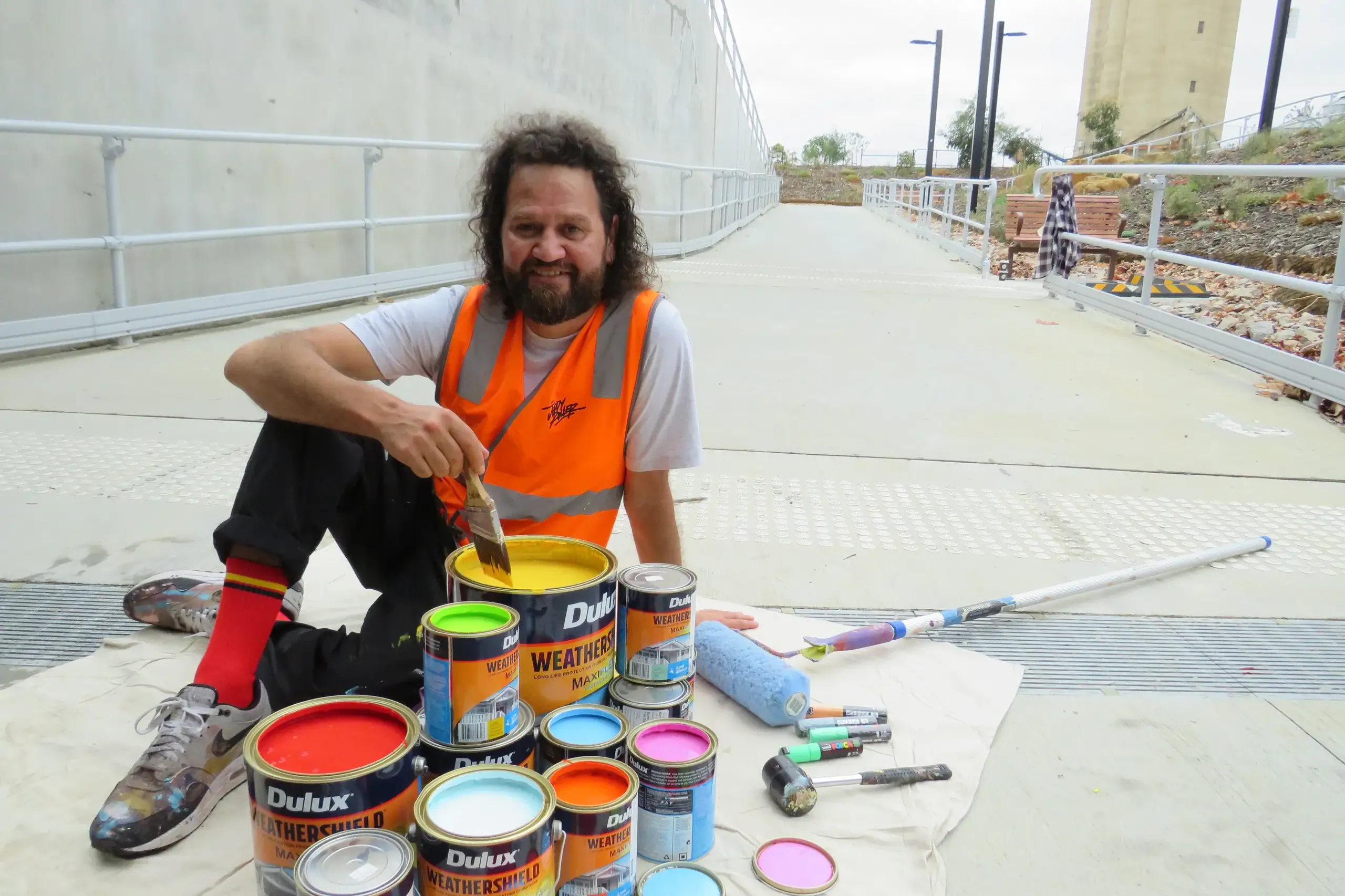 <p>INSPIRATION FROM COUNTRY: Artist Tommy Day was preparing to start work on his mural at the Wangaratta Railway Station underpass on Monday morning. He, fellow artist Matt Adnate and their team will be working throughout this week on the mural, which aims to reflect the colours, rhythms and landscape of the local area. The work is being curated and produced by Melbourne-based public art and placemaking studio Juddy Roller. PHOTO: Simone Kerwin</p>\\n