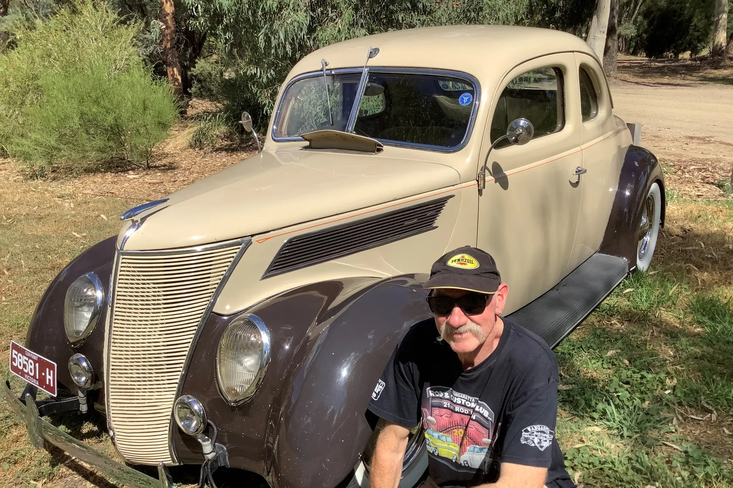 <p>HOT ROD: Neil Sinclair and one of his current cruisers; a 1937 American bodied Ford business coupe, which still runs, with an early Ford V8 flathead motor and crash gearbox. The coupe rides on an original chassis and suspension with artillery style wheels widened at the rear.</p>\\n