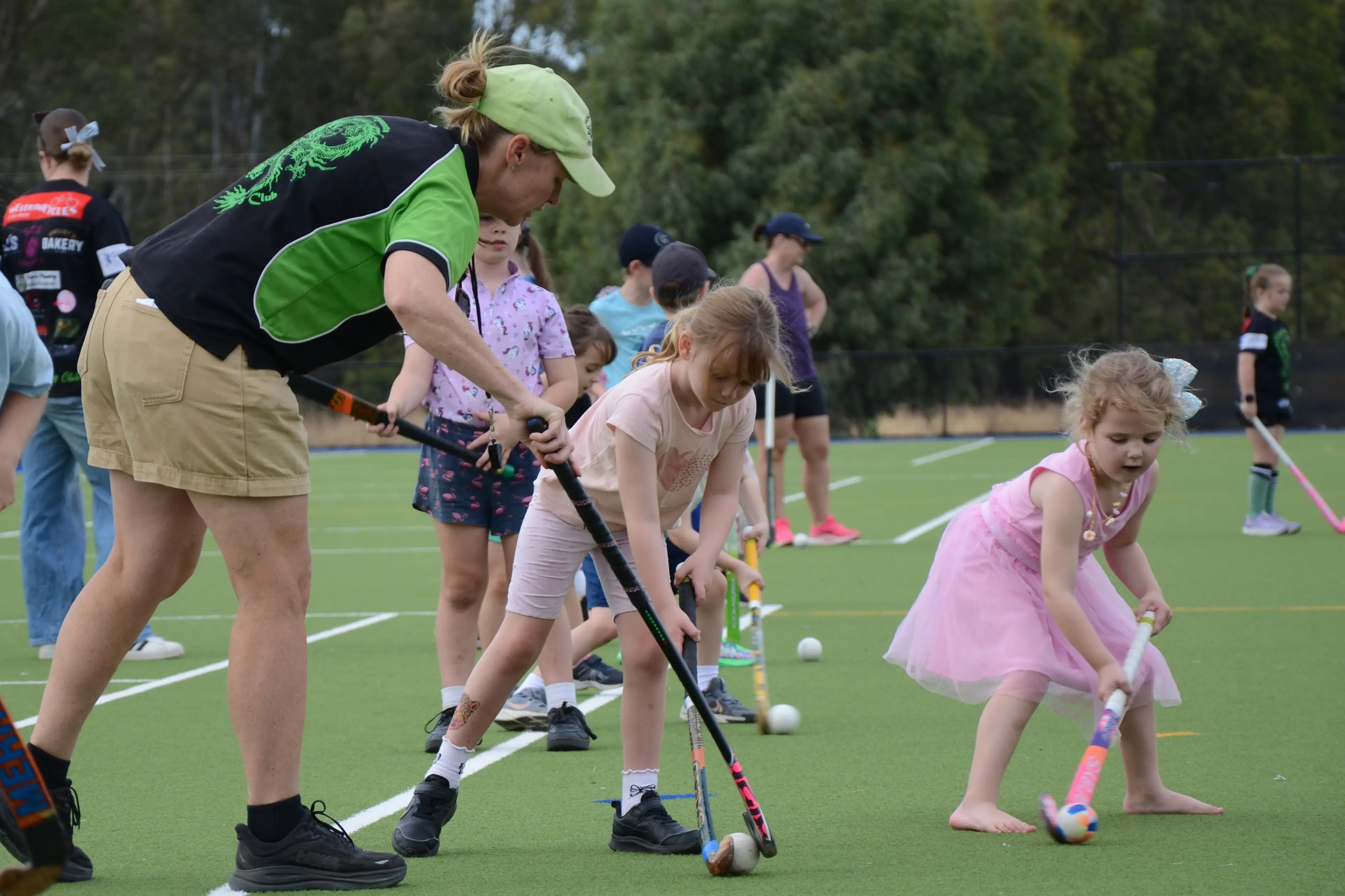 <p>FIRST STEPS: Kate Reilly guides some juniors through the basics of hockey at a come and try session. PHOTO: Wes Samson</p>\\n