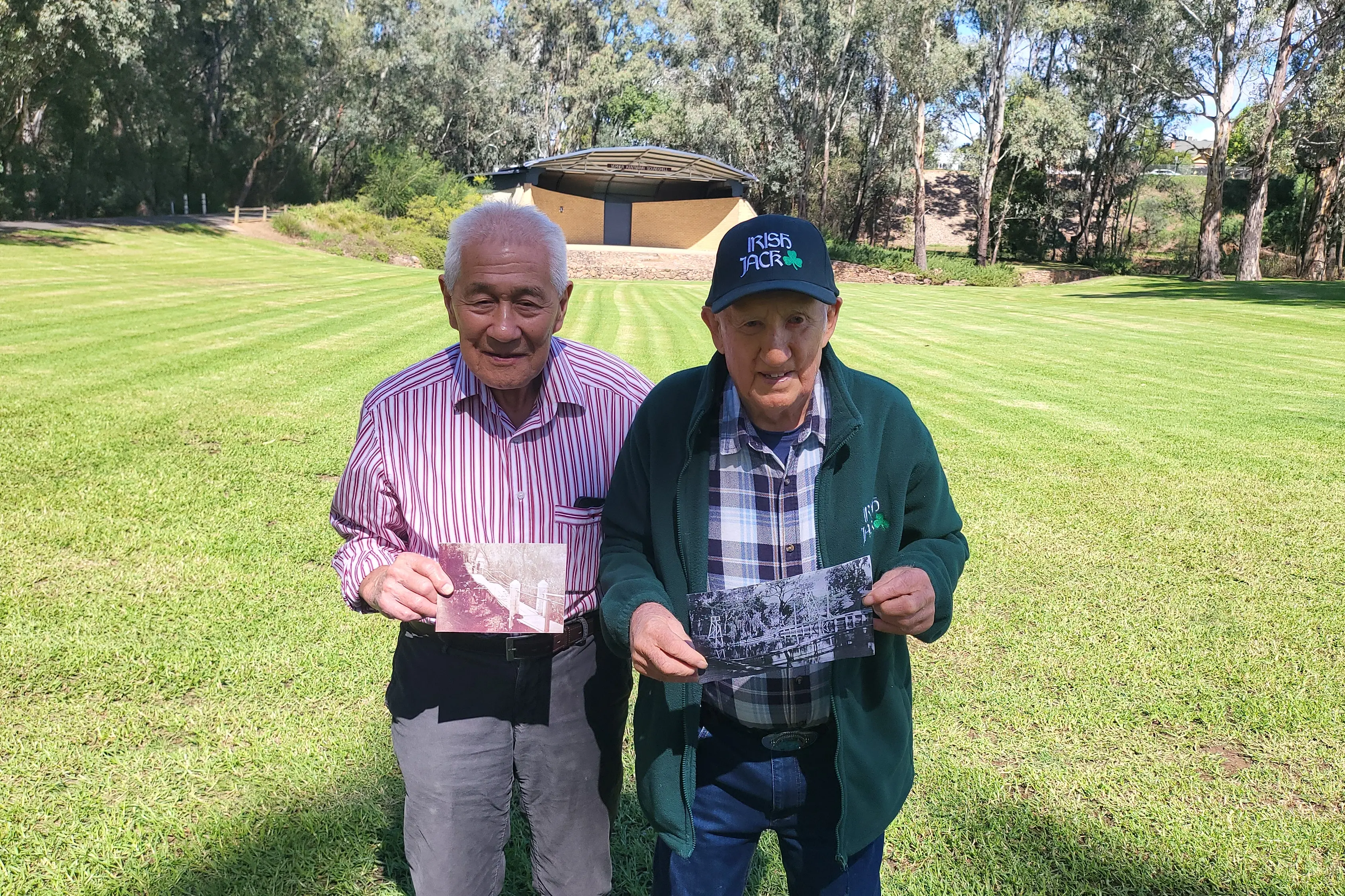 <p>THE WAY IT WAS: George Lee and Jack McGauran with photos of the swing bridge that used to be behind where they are standing at Merriwa Park. PHOTO: Steve Kelly</p>\\n