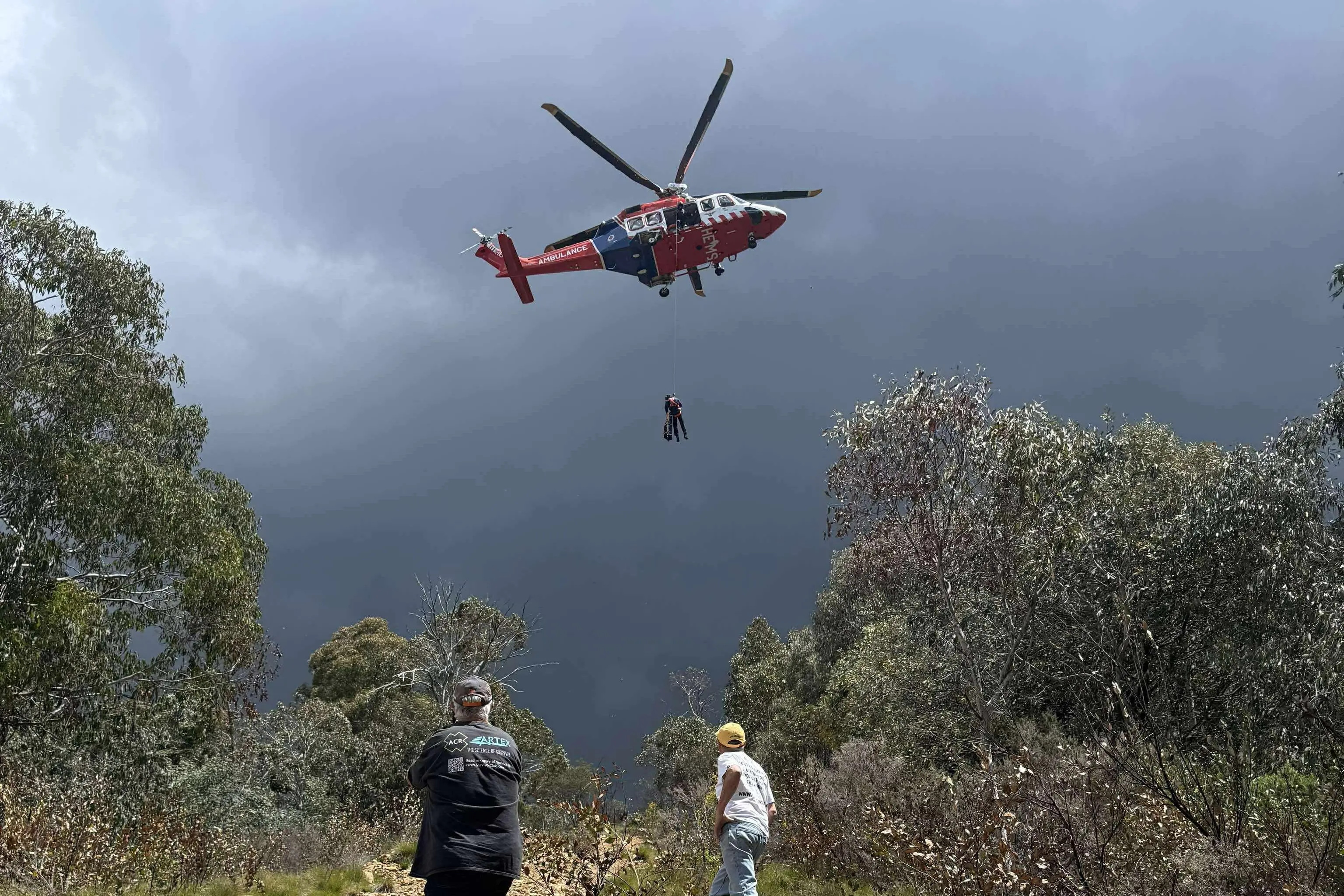 <p>HIGH DRAMA: A specialist Air Ambulance Victoria (AAV) helicopter crew winching patient Gary. </p>\\n