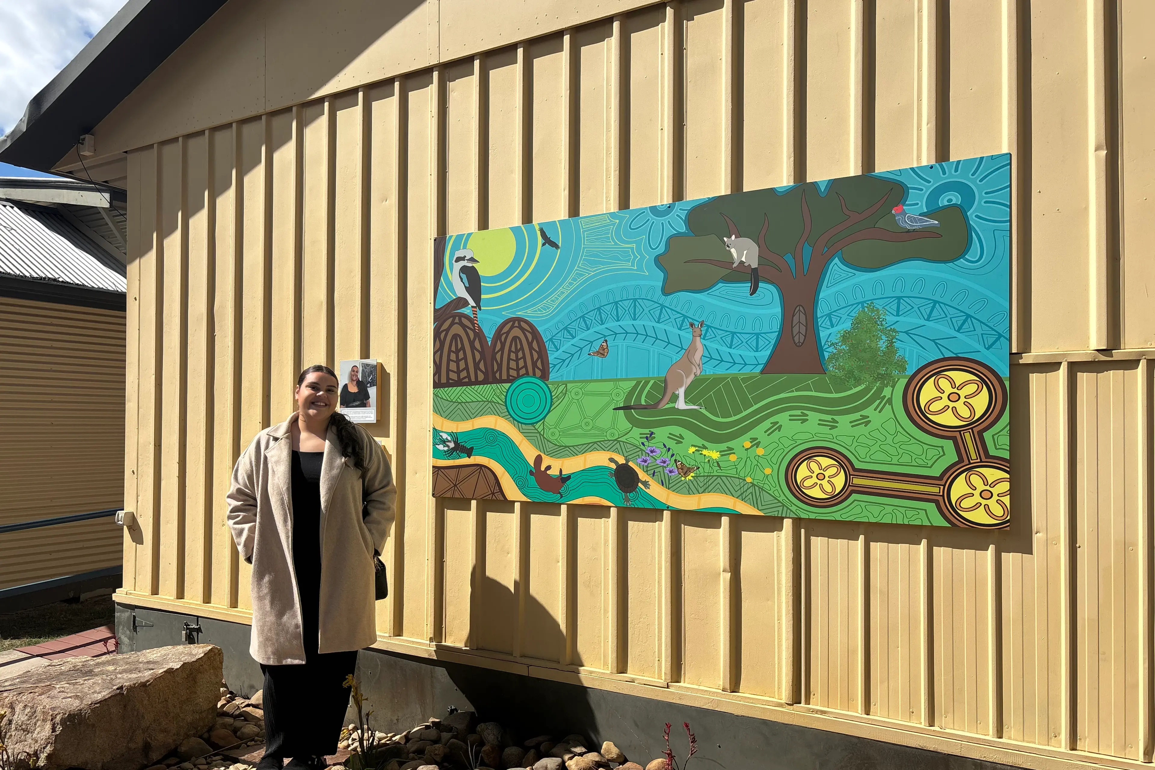 <p>ART GROUNDED IN CULTURE: Kiarna Atkinson\\'s first mural was revealed to a curious cohort of Porepunkah Primary School students at 15 Mile Creek Outdoor School, a project not only illustrating the school\\'s surrounding Country, wildlife and landmarks, but also symbolising unity, growth and connection. </p>\\n