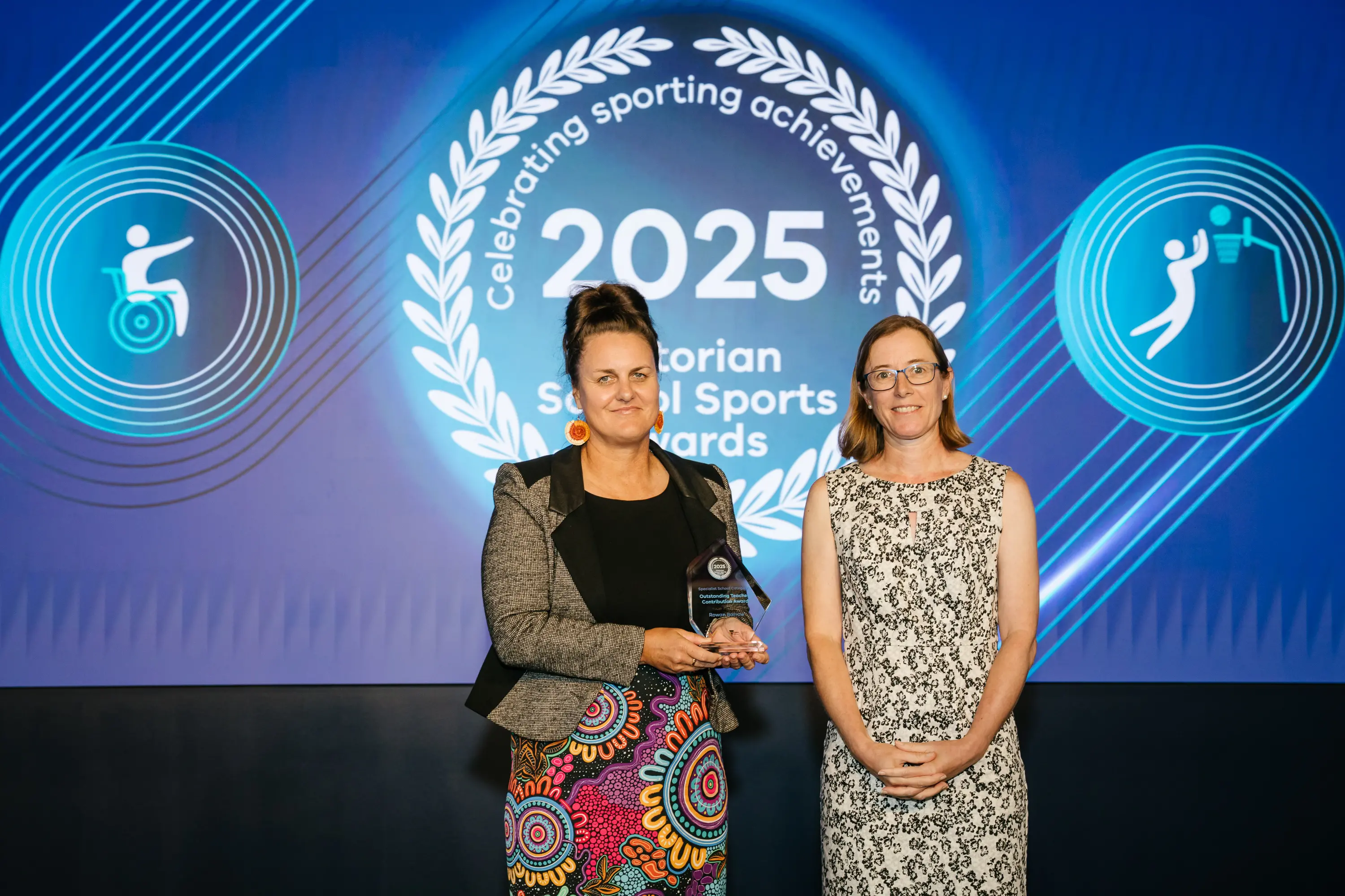 <p>RECOGNITION: Rowan Barrow (left) receives her outstanding teacher contribution award at the 2025 Victorian School Sports Awards presentation held last month.  PHOTO: SSV</p>\\n