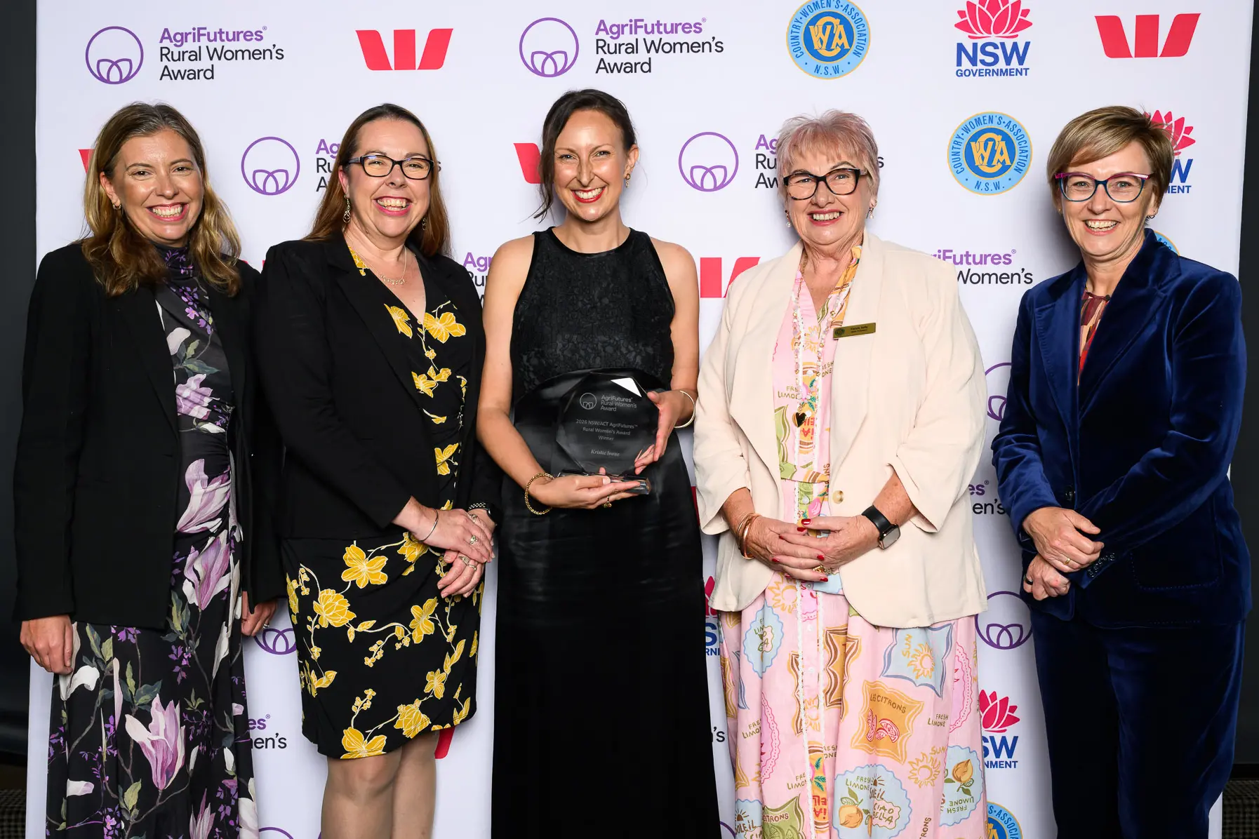 <p>All SMILES: Kristie Ivone, founder of Boas Language Academy (centre) is pictured receiving her award with (from left) Tamara Bryden, managing director of business lending at Westpac; Brianna Casey, managing director of AgriFutures Australia; Tanya Jolly, state president of NSW Country Women\\'s Association; and Jodie Harrison, Minister for Women, Minister for Seniors, and Minister for the Prevention of Domestic Violence and Sexual Assault.</p>\\n