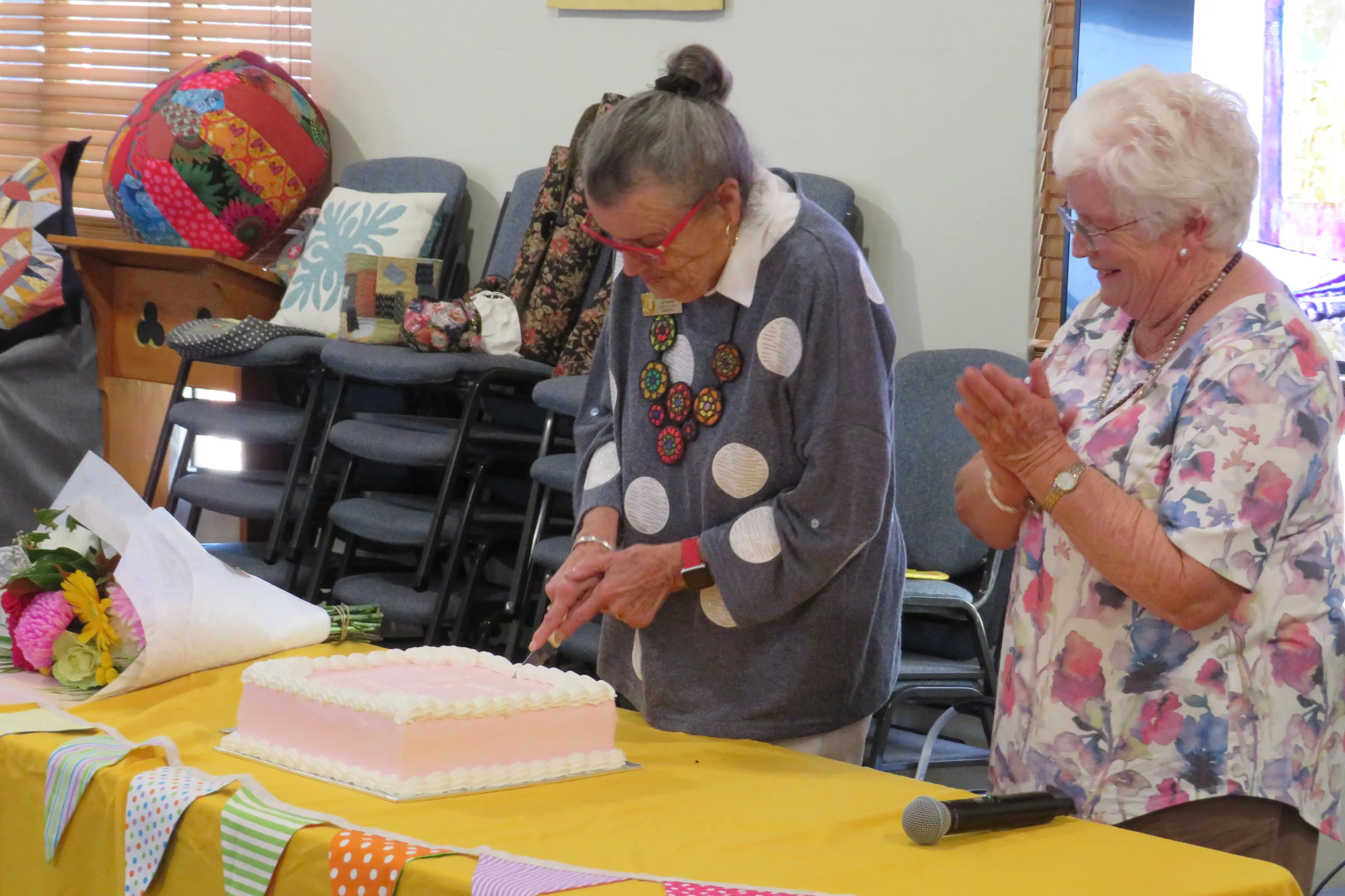 <p>Barb McCabe cuts the Centre Quilters\\' birthday cake as Robyn Grealy looks on.</p>\\n