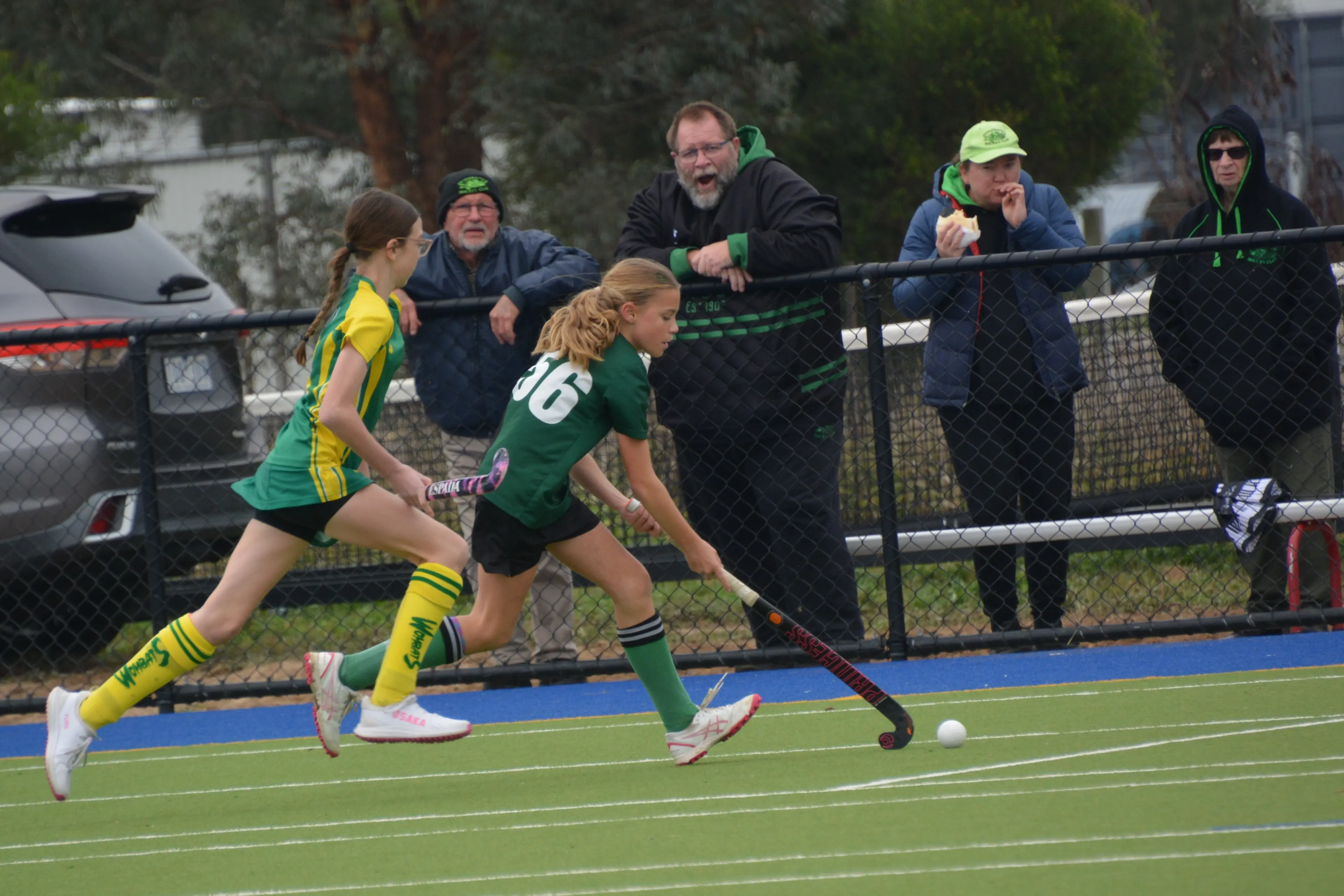 <p>GO DRAGONS: Amelie Reilly runs up the field, cheered on by club president Daniel Warner. PHOTO: Kylie Samson</p>\\n