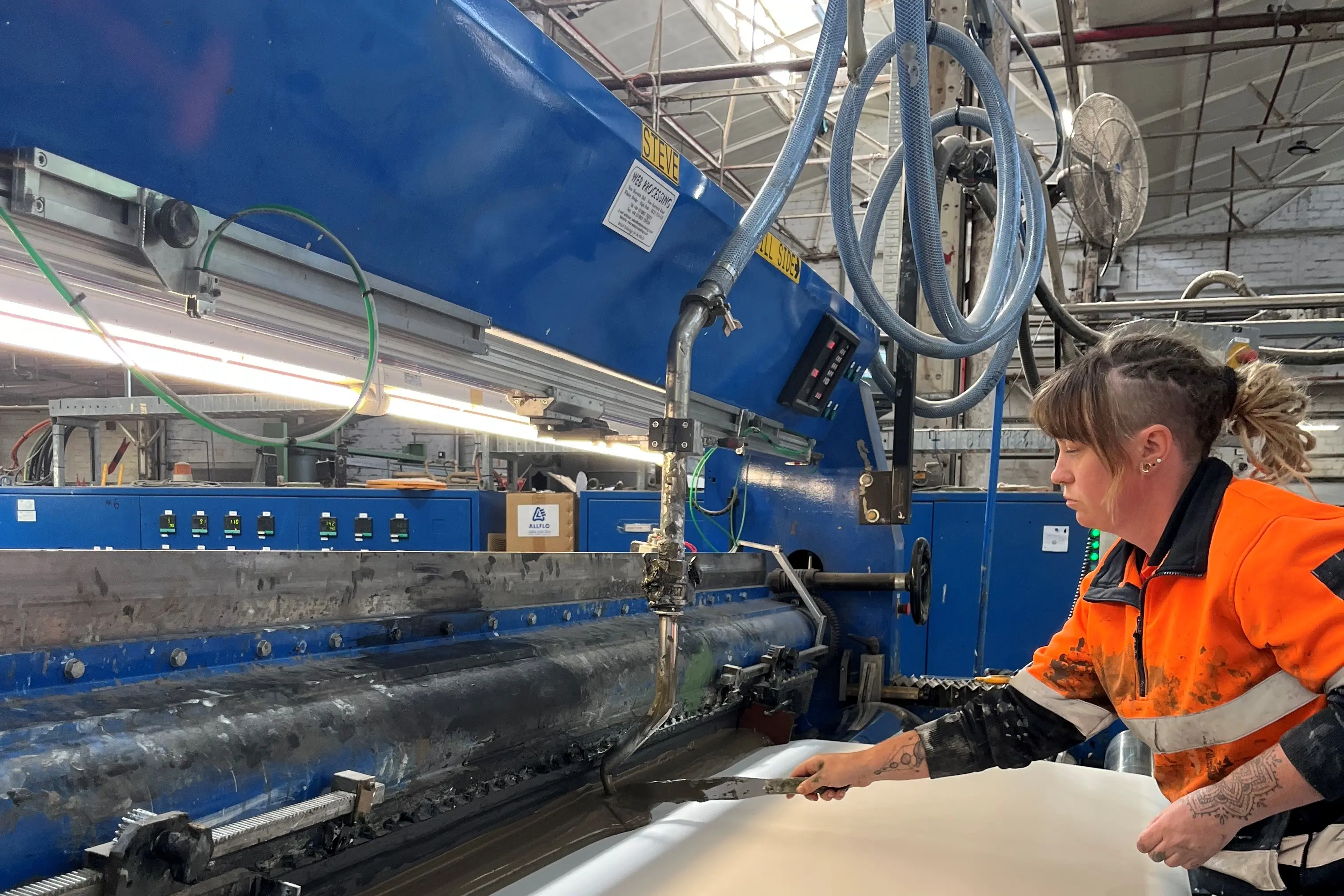 <p>DIVERSIFICATION: Coating machine operator Kitty Dwyer works on the production of camouflage-printed fabric MAXICAM, as part of the Australian Outdoor Fabrics range.</p>\\n