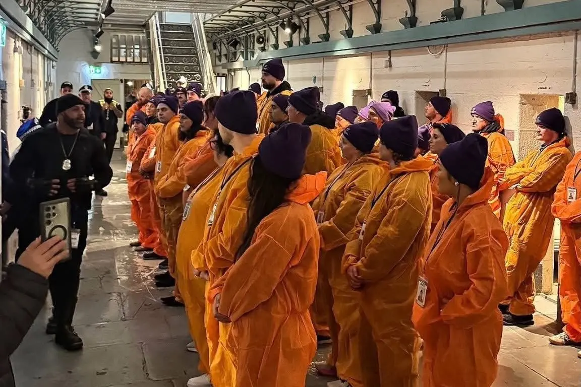 <p>EXPERIENCING INCARCERATION: Fundraising participants including Peter Simpson line up in front of guards in Pentridge Prison as part of Bail Out Melbourne.  PHOTO: Big Brothers Big Sisters</p>\\n